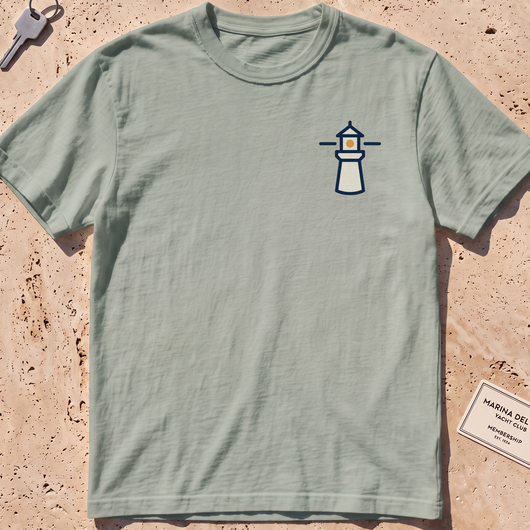 bay heavyweight tee with a small lighthouse crest graphic.