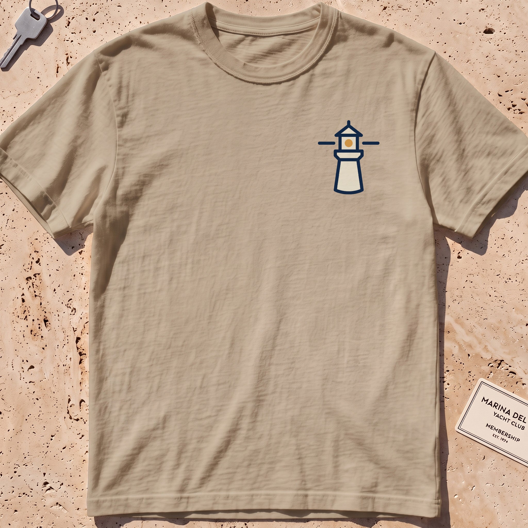 khaki heavyweight tee with a small lighthouse crest graphic.