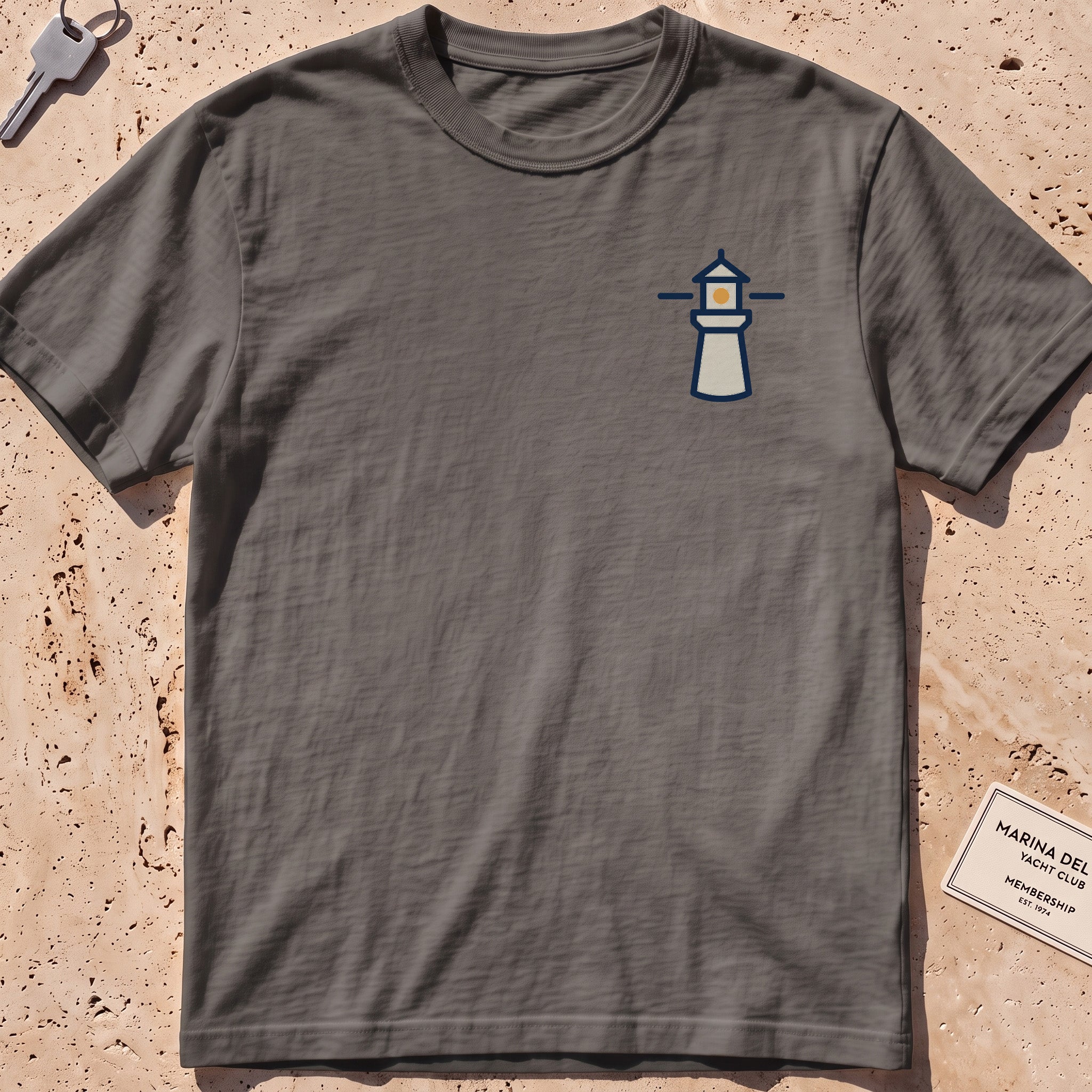 pepper heavyweight tee with a small lighthouse crest graphic.