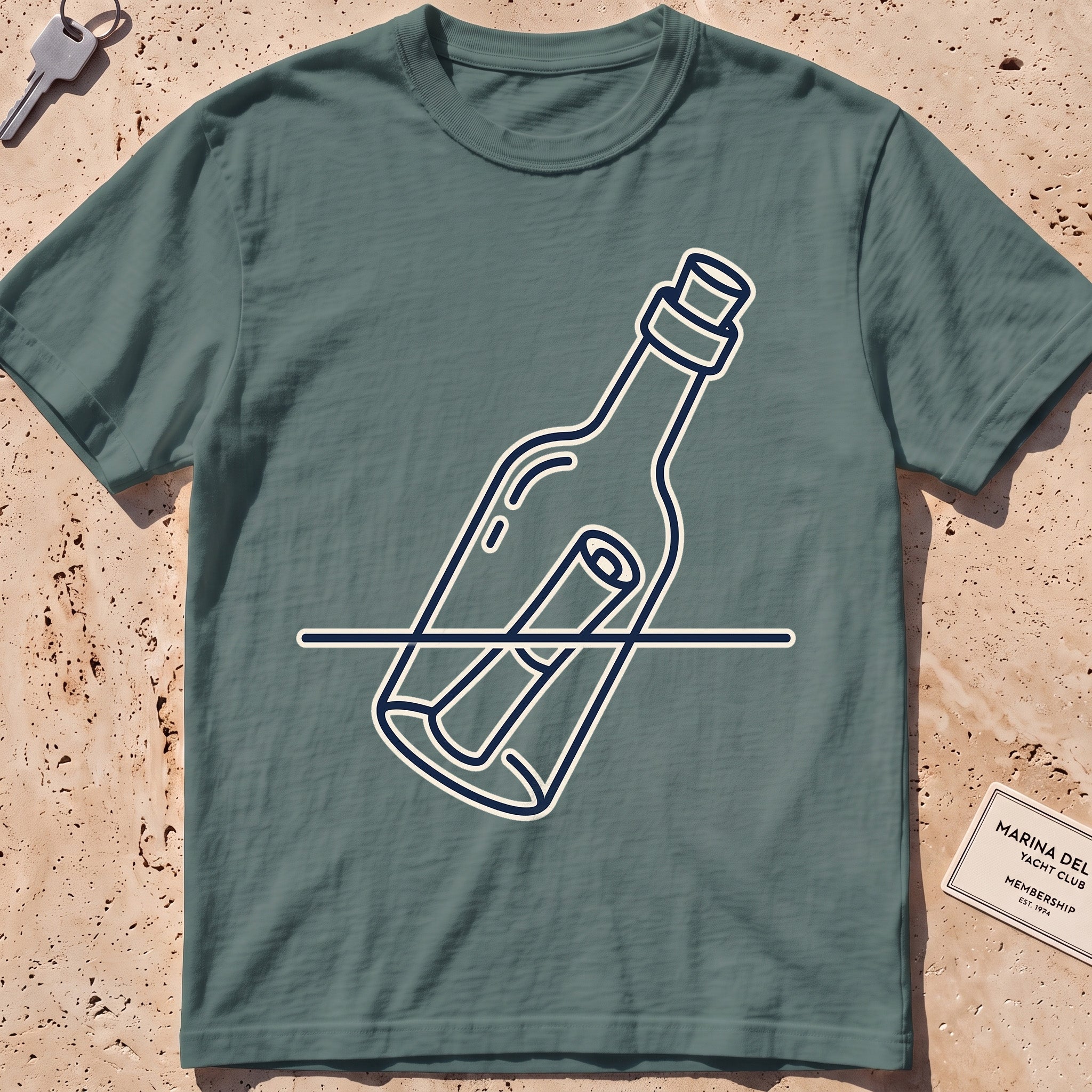 Blue Spruce heavyweight tee with a single-line message-in-a-bottle "Adrift" graphic