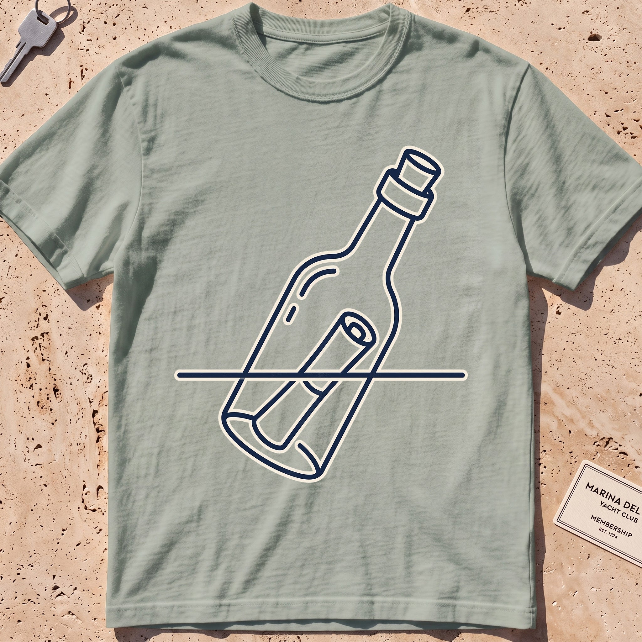 Bay heavyweight tee with a single-line message-in-a-bottle "Adrift" graphic