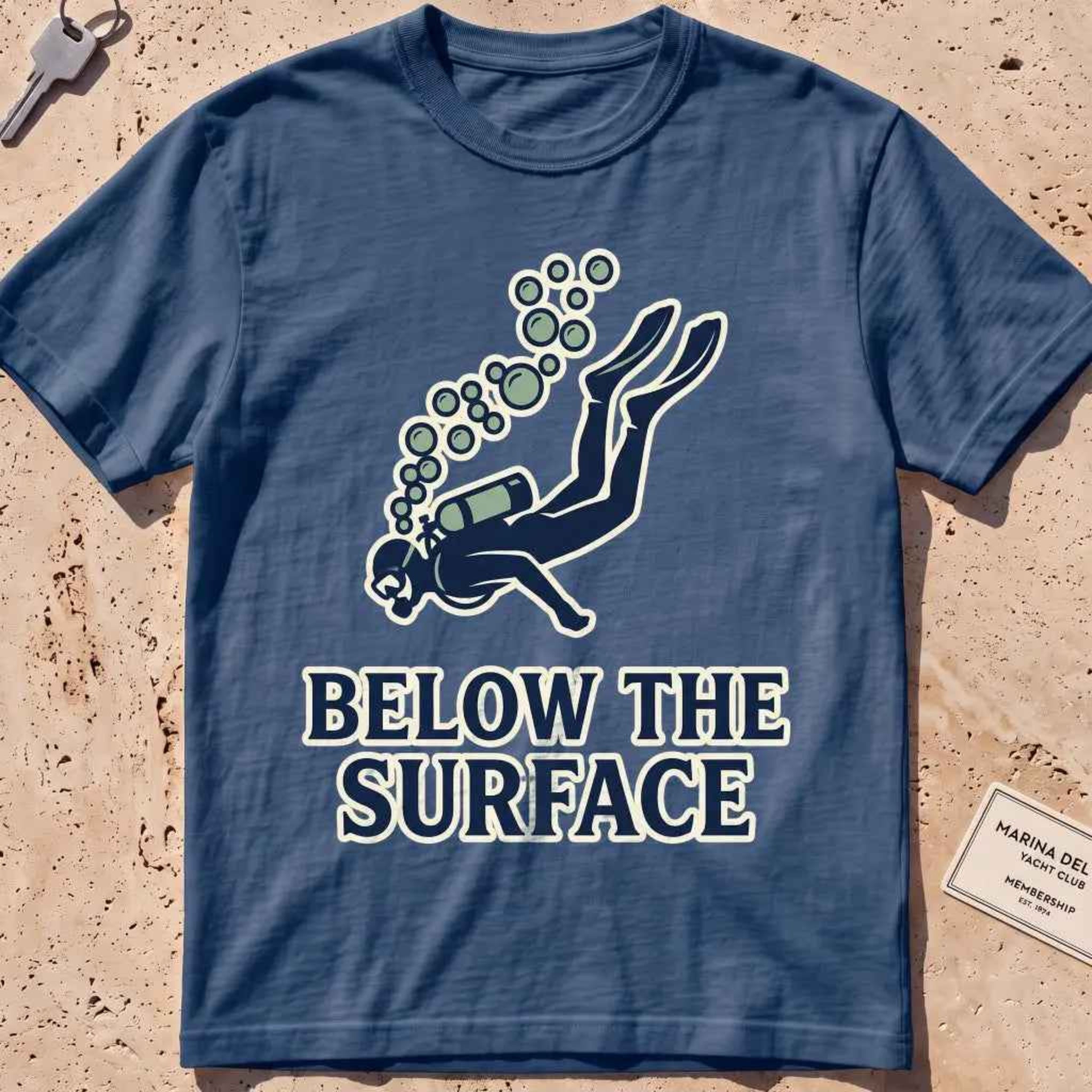 Midnight heavyweight tee with a minimalist scuba diver and rising bubbles graphic.