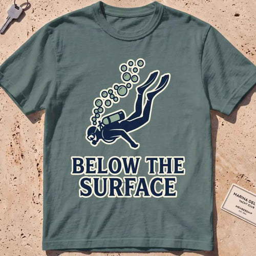 Blue spruce heavyweight tee with a minimalist scuba diver and rising bubbles graphic.