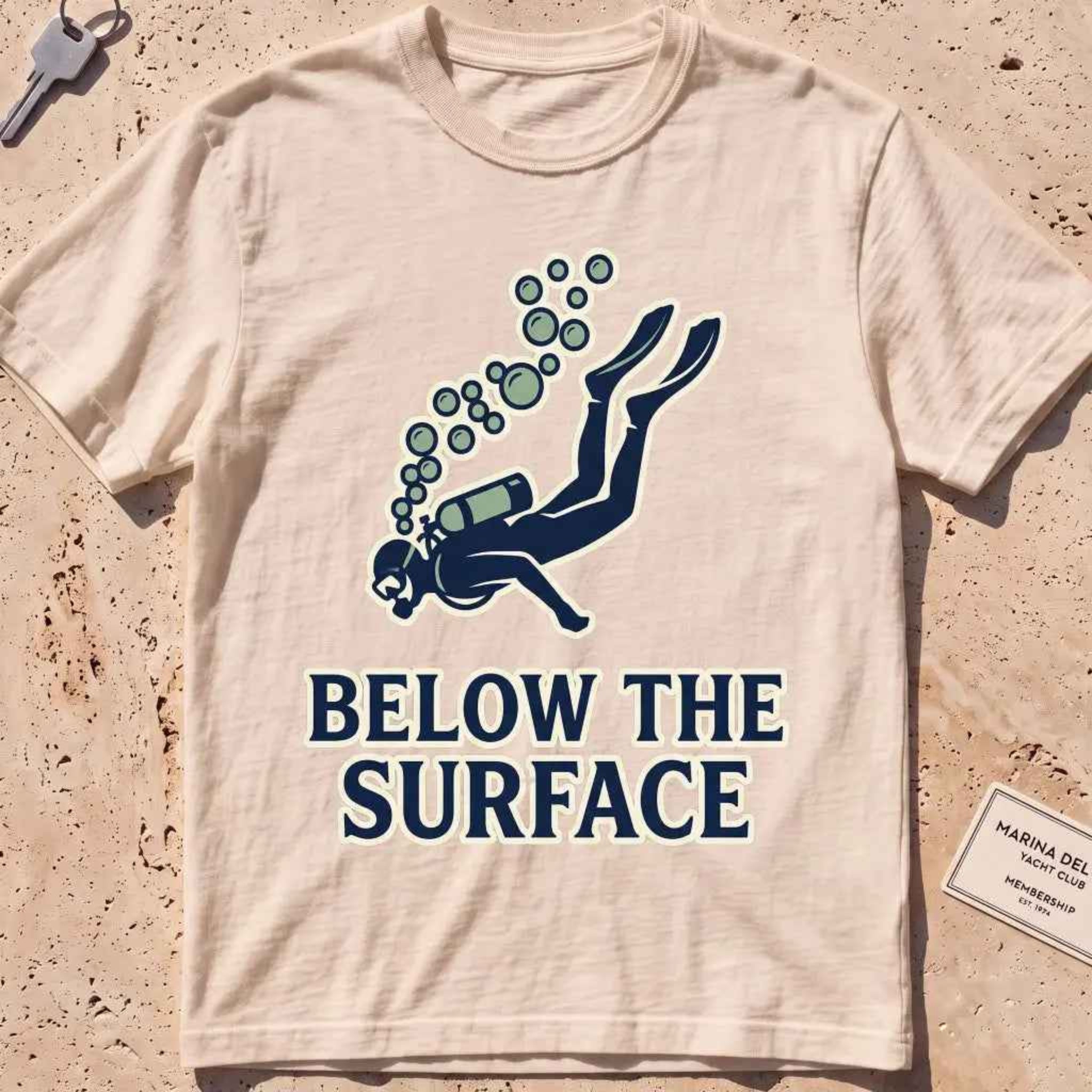 Ivory heavyweight tee with a minimalist scuba diver and rising bubbles graphic.
