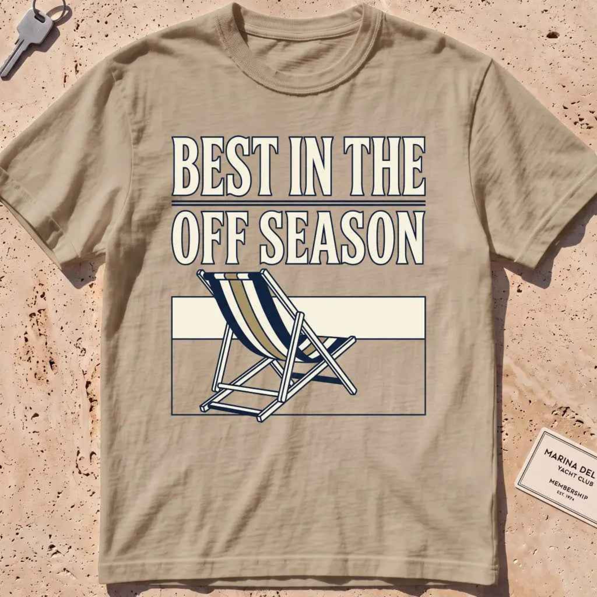 Khaki heavyweight tee with "Best in the Off Season" text and an empty deckchair graphic.