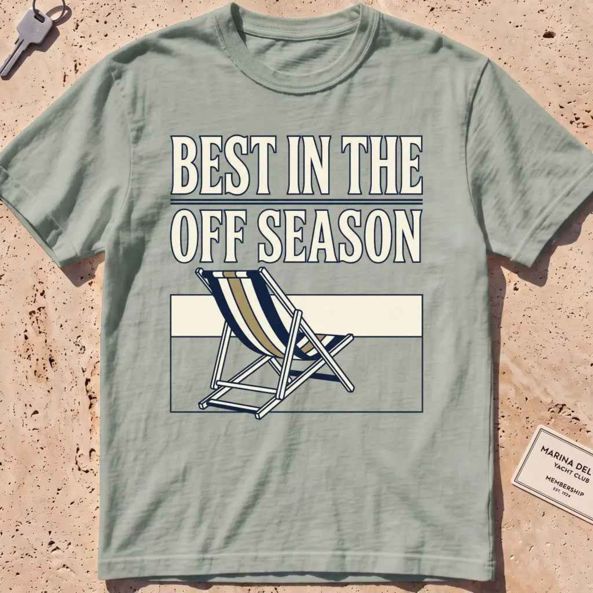 Bay heavyweight tee with "Best in the Off Season" text and an empty deckchair graphic.