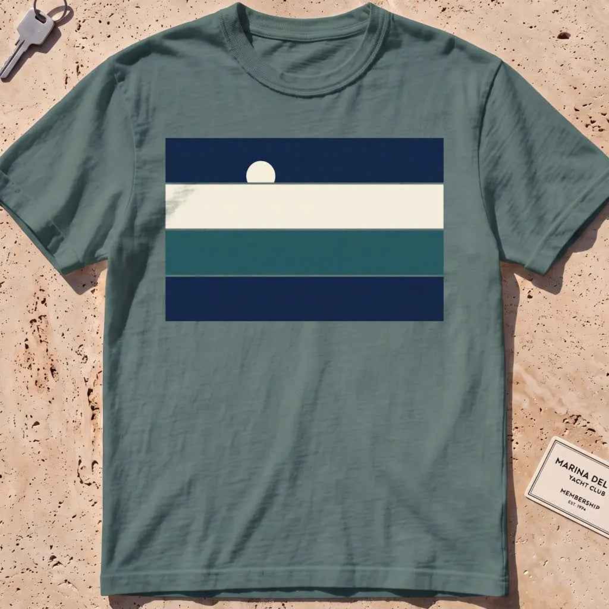 Blue spruce heavyweight tee with stacked sea-and-sky colour bands and a rising moon.