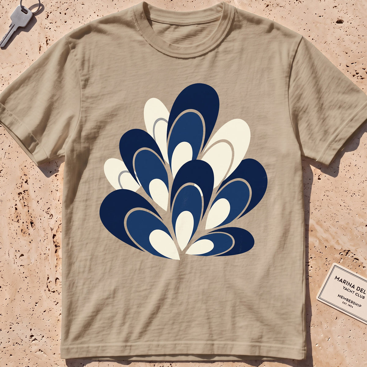 ivory heavyweight tee with a flat-geometric blue mussel cluster graphic.