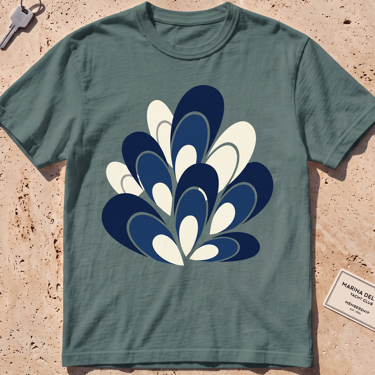 blue spruce heavyweight tee with a flat-geometric blue mussel cluster graphic.