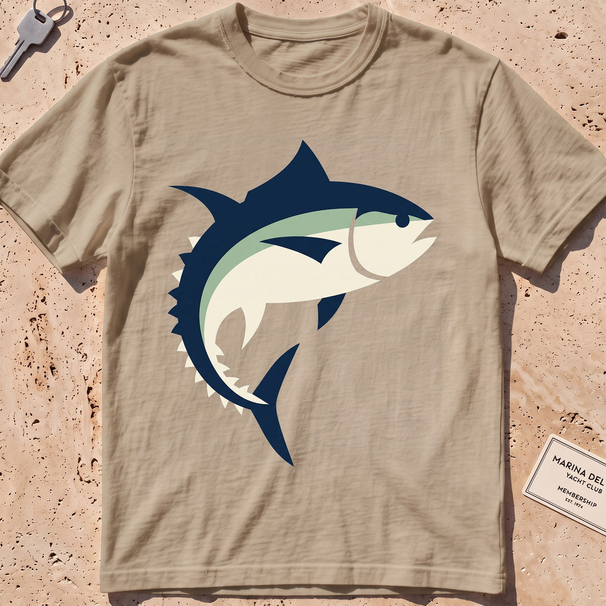 khaki heavyweight tee with a flat-geometric bluefin tuna graphic.