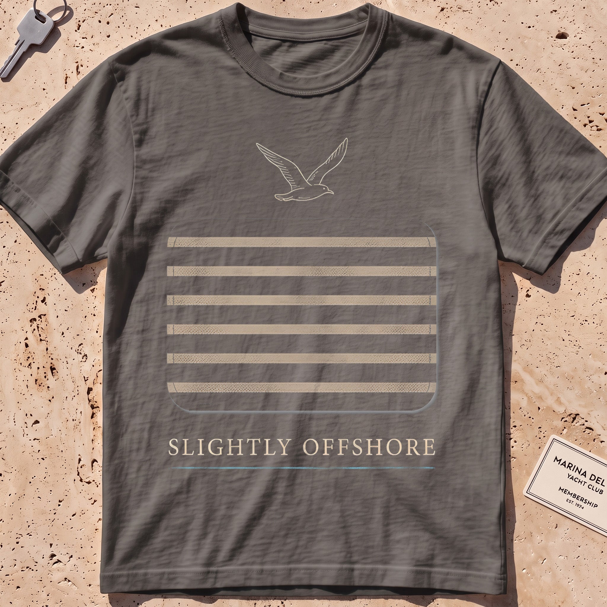 pepper heavyweight tee with a Breton-stripe patch and a small seabird graphic.