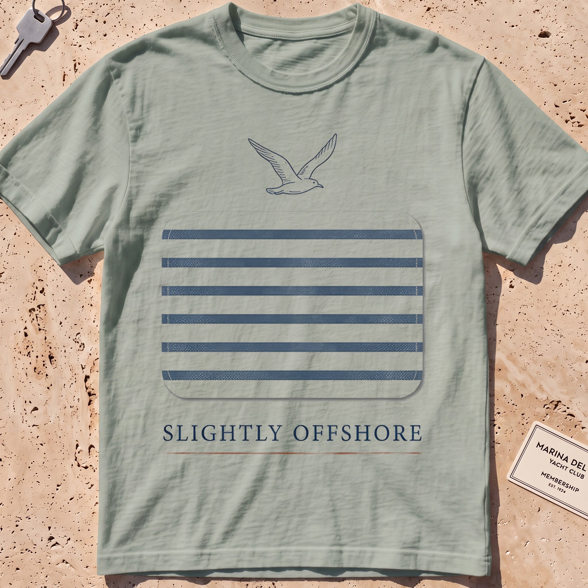 bay heavyweight tee with a Breton-stripe patch and a small seabird graphic.