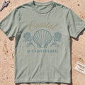 bay heavyweight tee with a shell and hydrangea "Coastal and Unbothered" graphic.