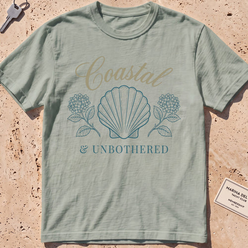 bay heavyweight tee with a shell and hydrangea "Coastal and Unbothered" graphic.