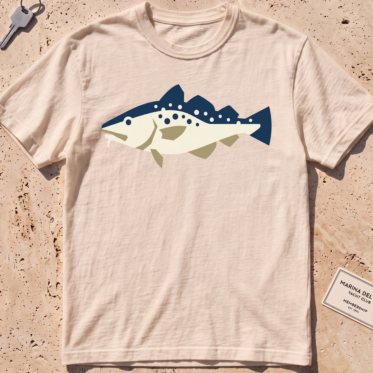 ivory heavyweight tee with a flat-geometric Atlantic cod graphic.