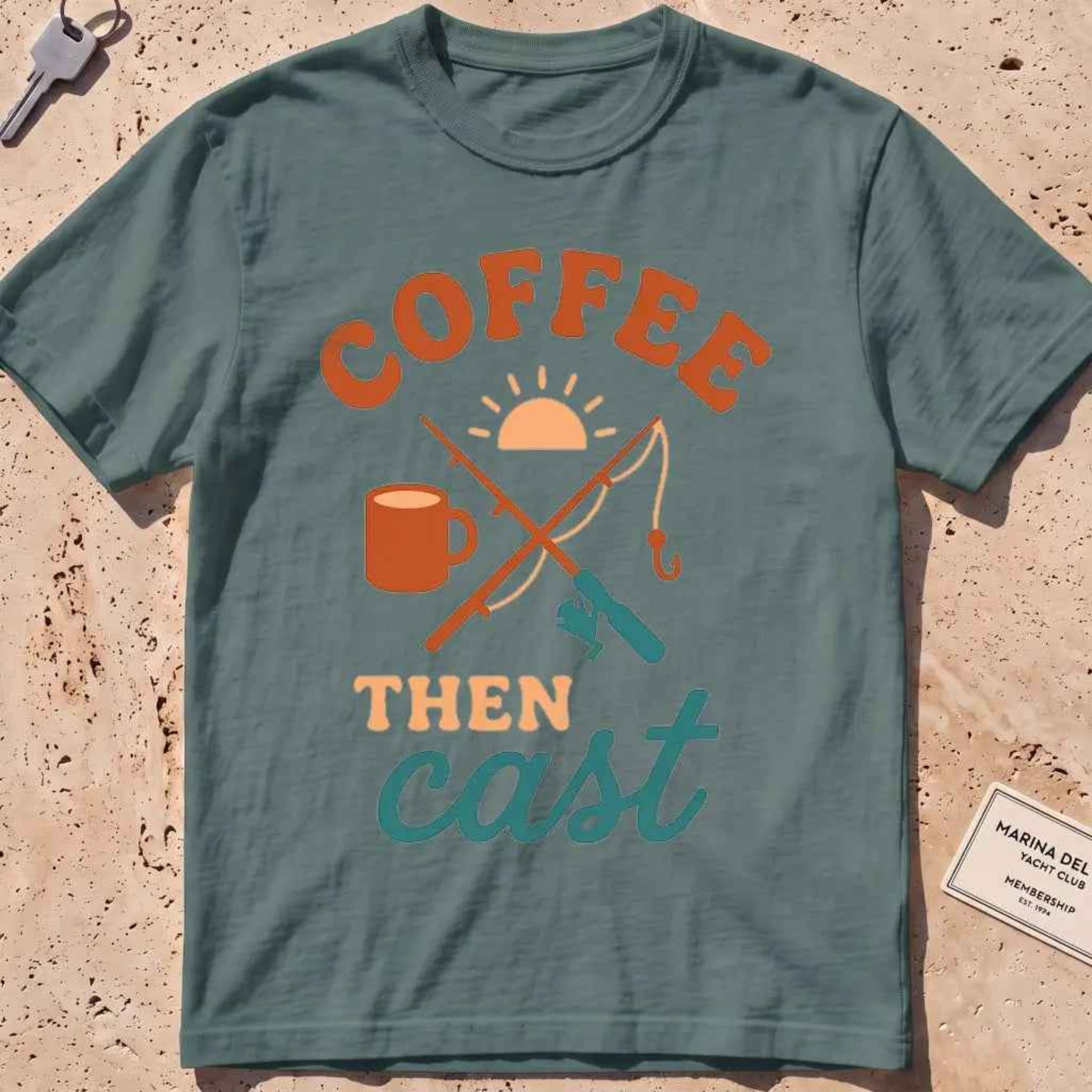 Blue spruce heavyweight tee with a coffee mug, crossed rods and "Coffee Then Cast" text.