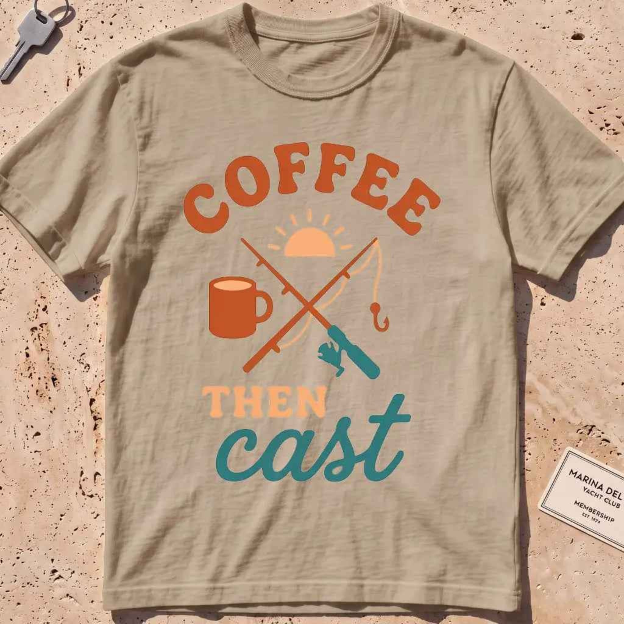 khaki heavyweight tee with a coffee mug, crossed rods and "Coffee Then Cast" text.