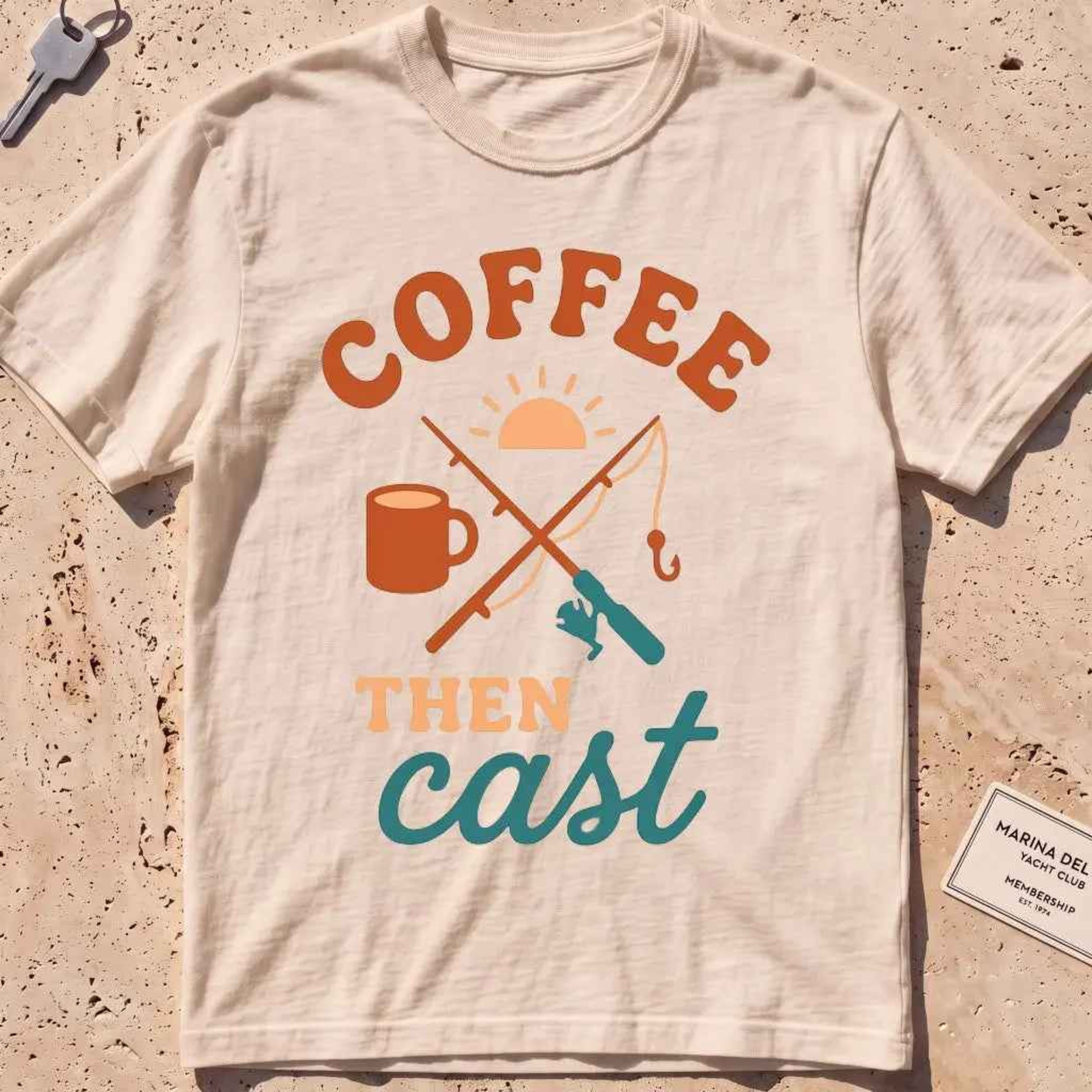 ivory heavyweight tee with a coffee mug, crossed rods and "Coffee Then Cast" text.