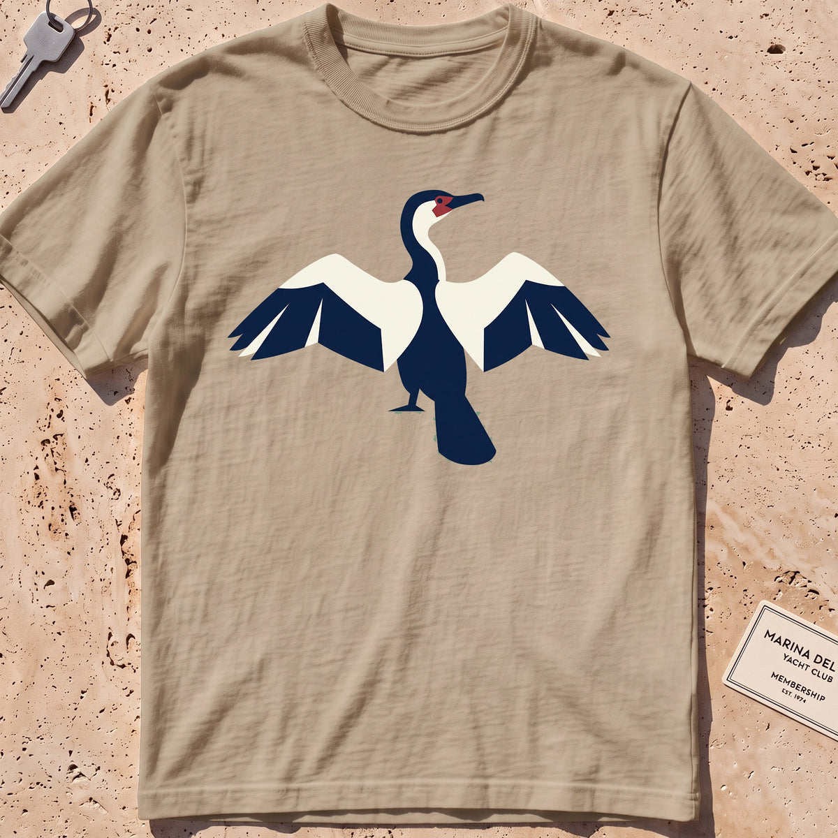 khaki heavyweight tee with a flat-geometric cormorant, wings spread graphic.