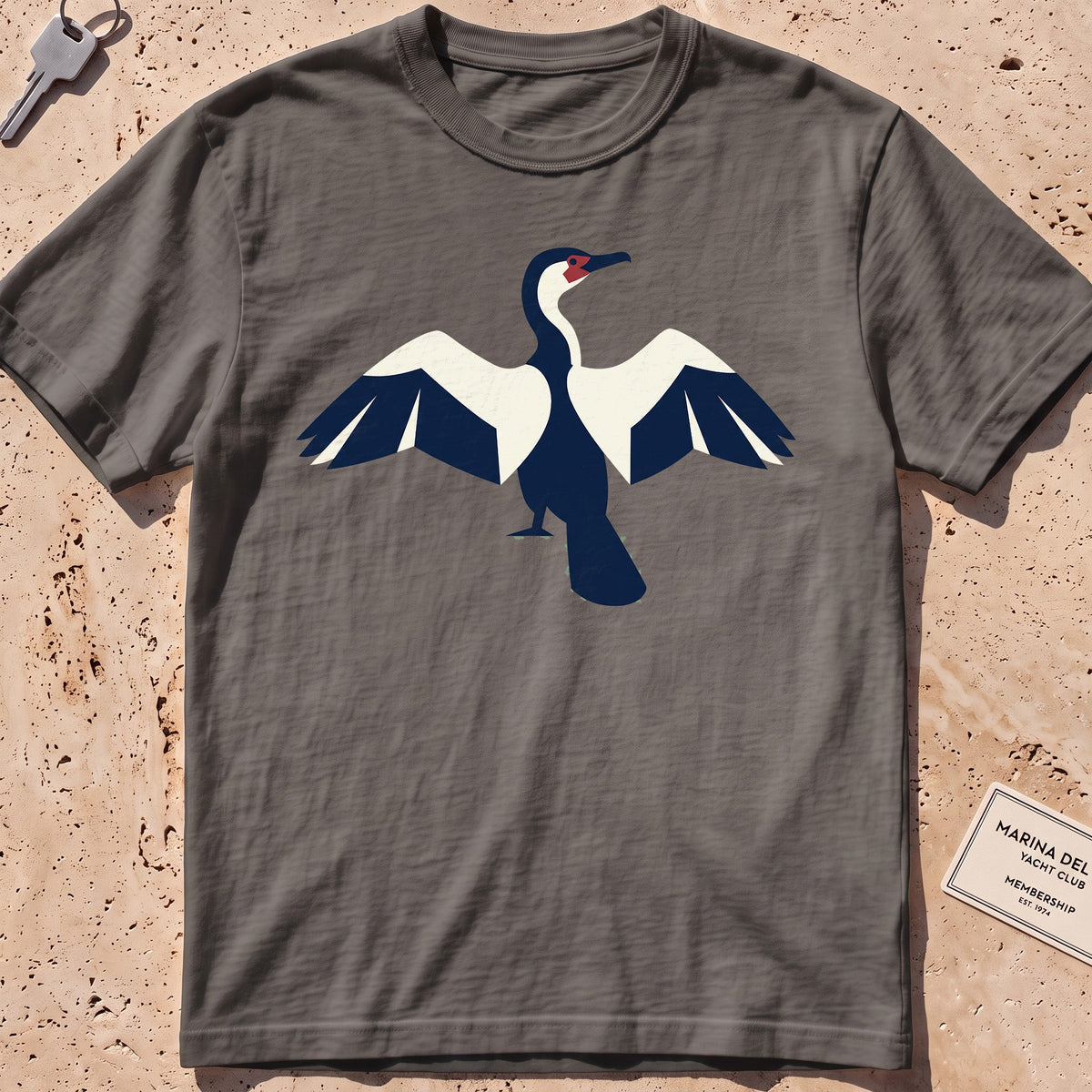 pepper heavyweight tee with a flat-geometric cormorant, wings spread graphic.