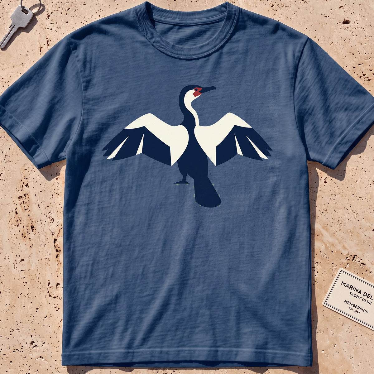midnight heavyweight tee with a flat-geometric cormorant, wings spread graphic.