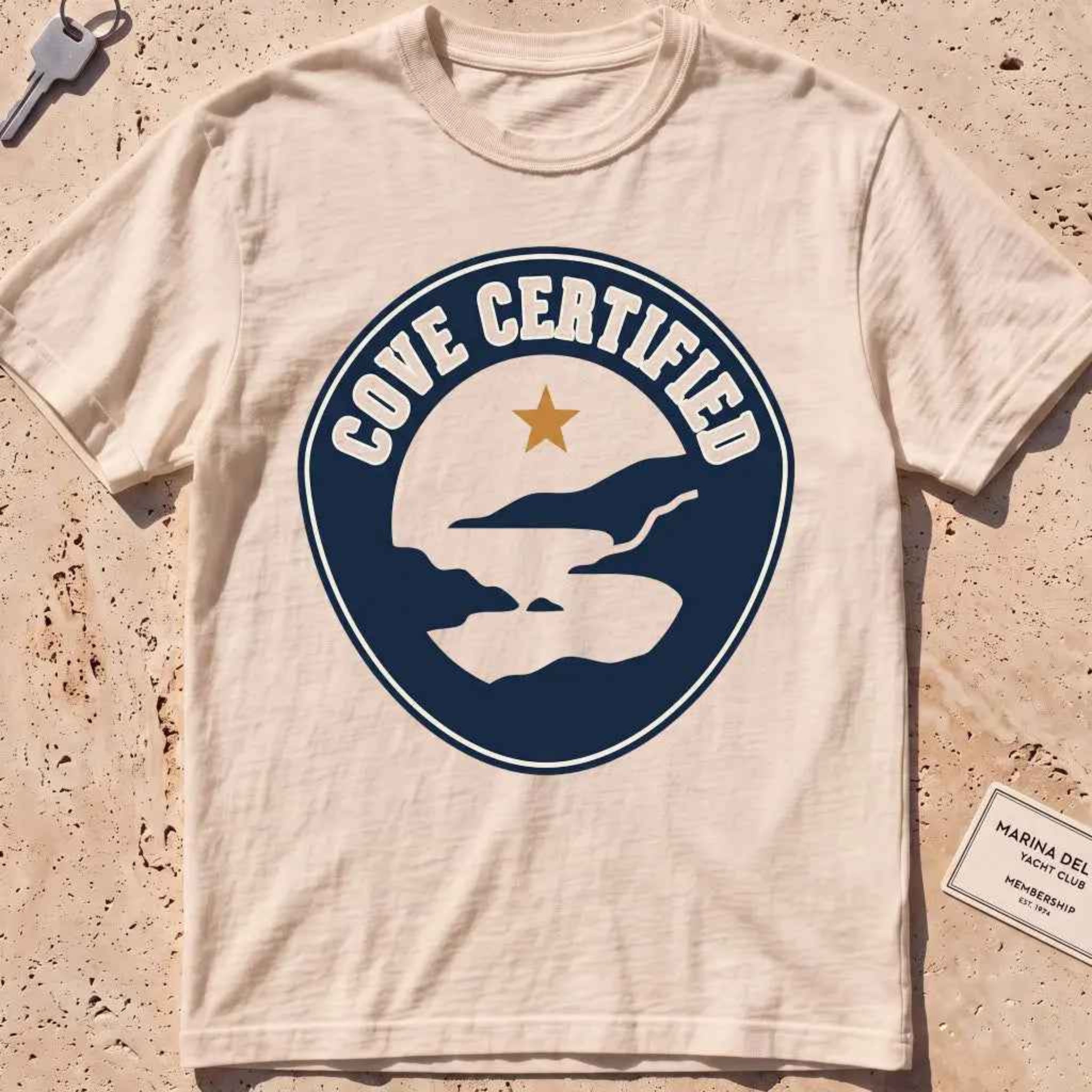 ivory heavyweight tee with a mock "Cove Certified" certification badge graphic.