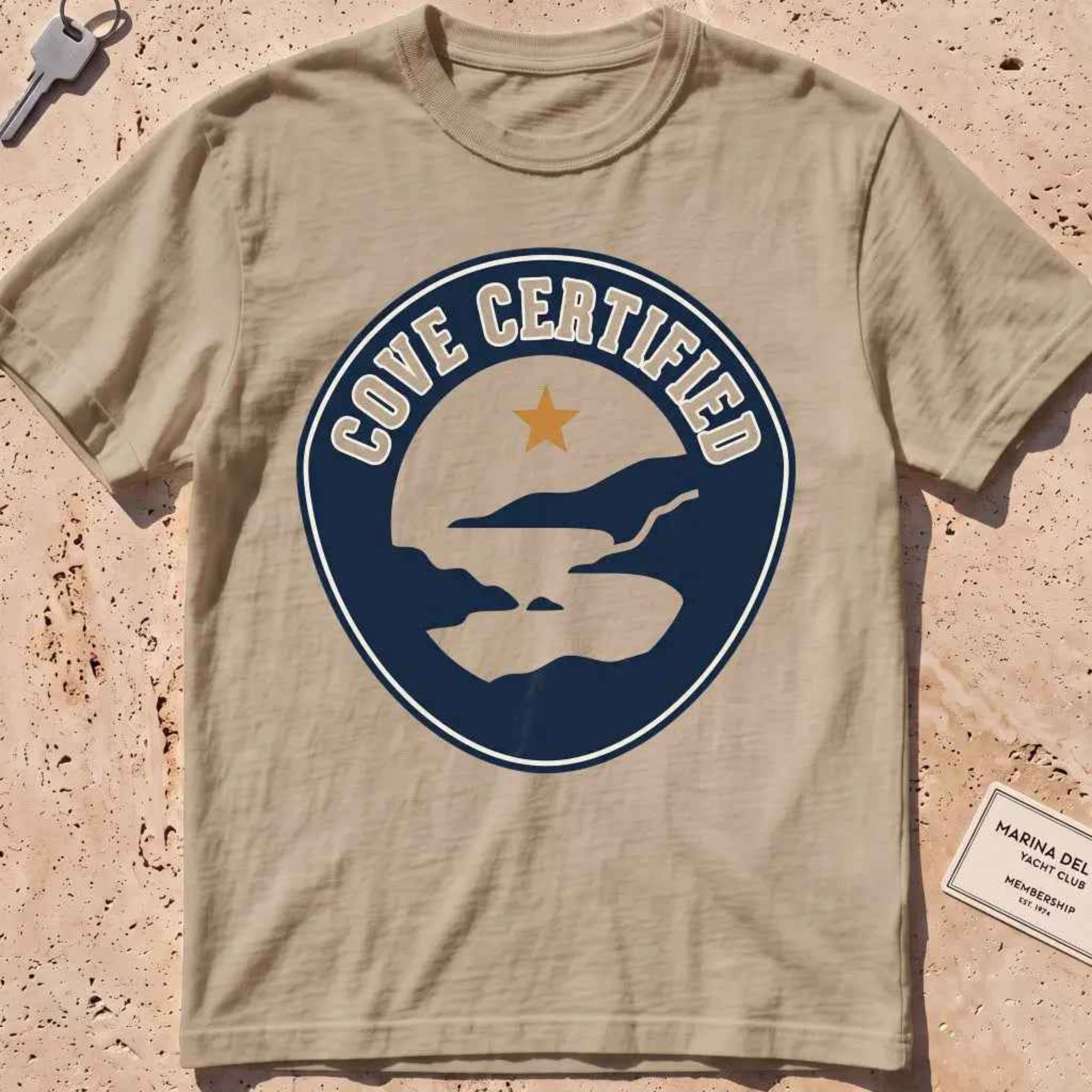 khaki heavyweight tee with a mock "Cove Certified" certification badge graphic.