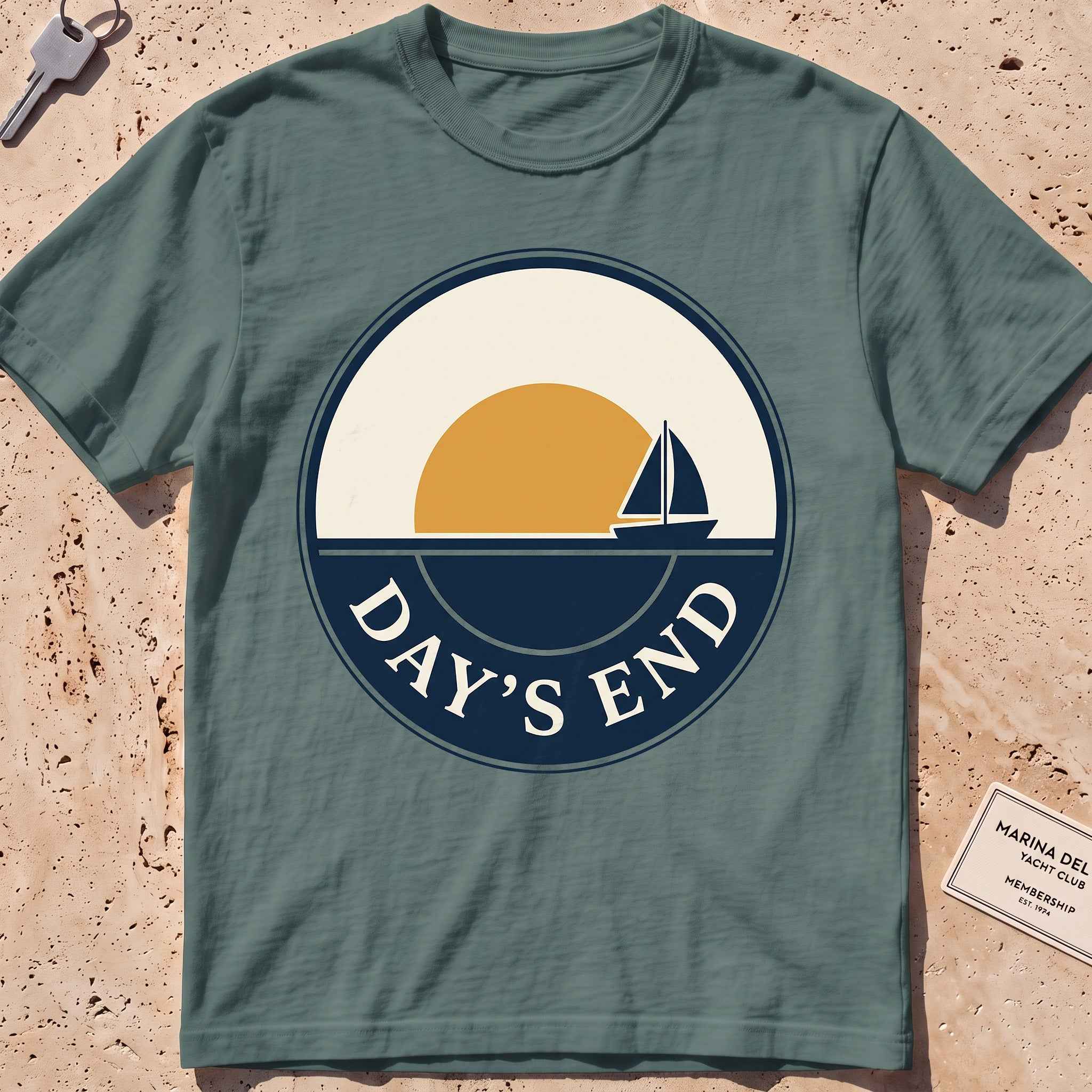 blue spruce heavyweight tee with a bold "Day's End" sunset badge graphic.
