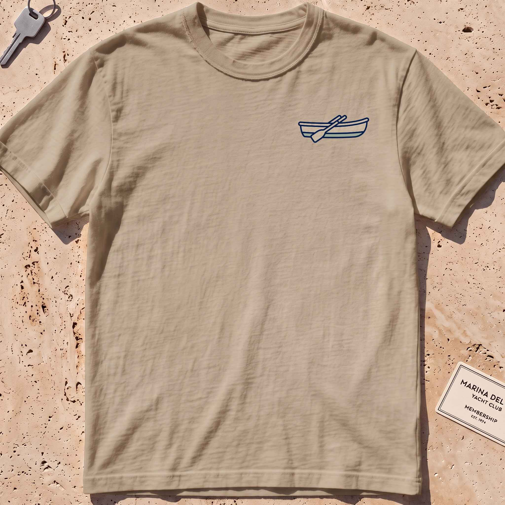 khaki heavyweight tee with a rowing-dinghy crest graphic.