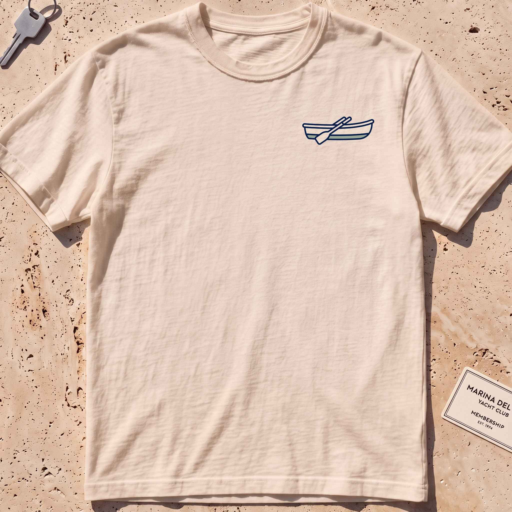 ivory heavyweight tee with a rowing-dinghy crest graphic.