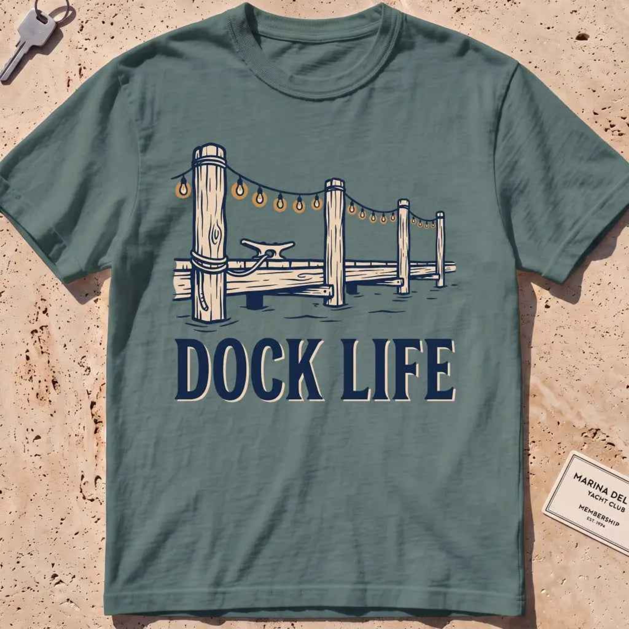 blue spruce heavyweight tee with dock pilings and string lights "Dock Life" graphic.