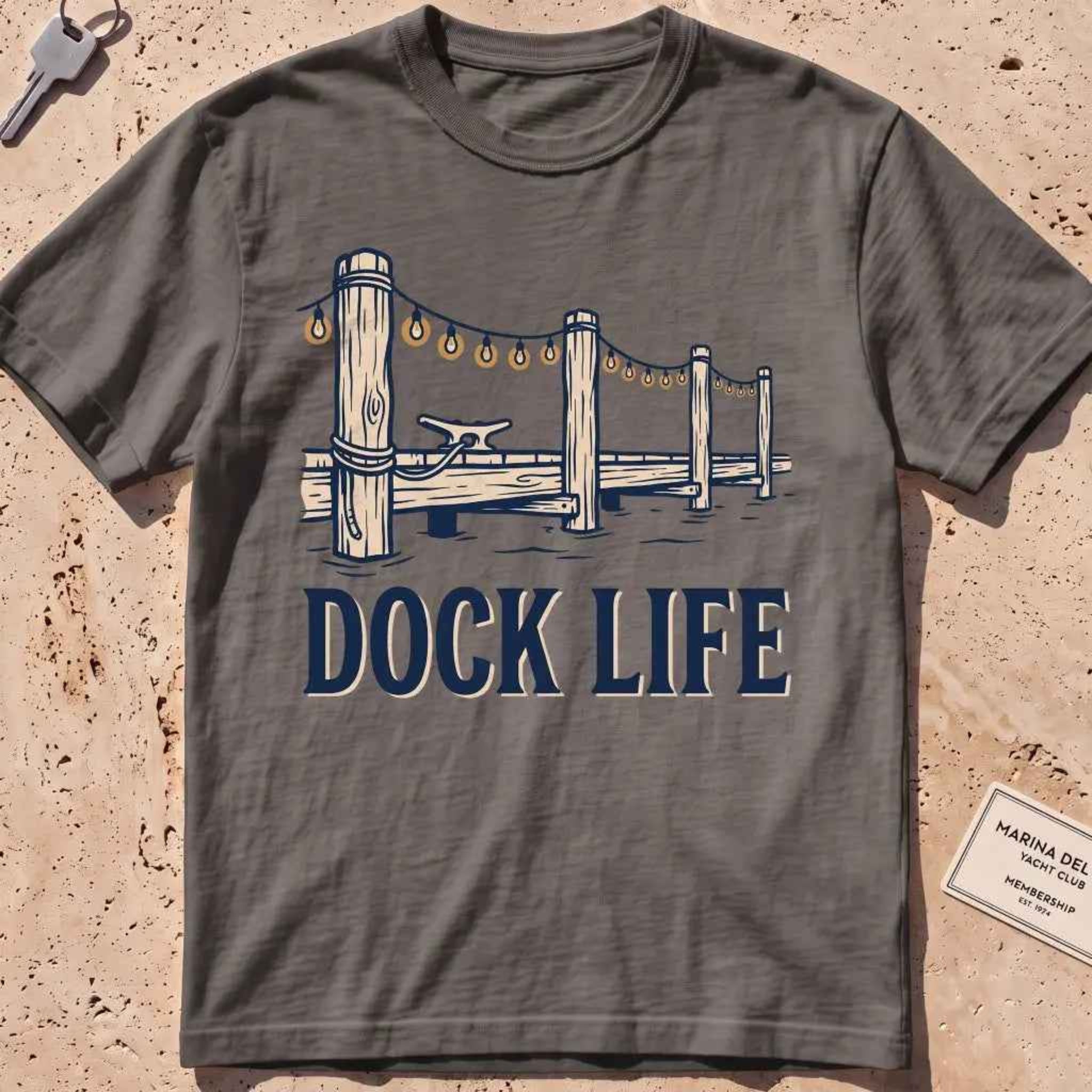 pepper heavyweight tee with dock pilings and string lights "Dock Life" graphic.