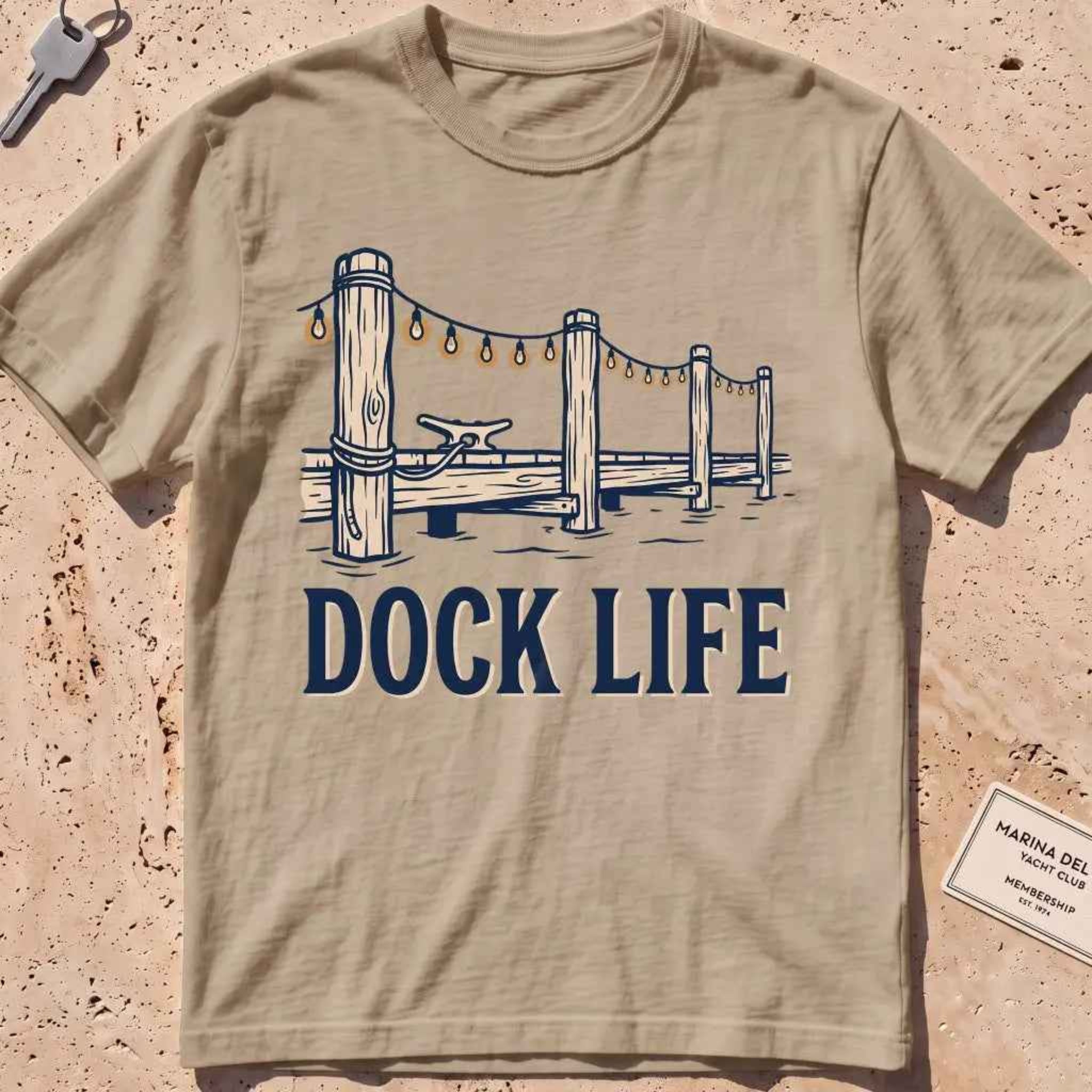 khaki heavyweight tee with dock pilings and string lights "Dock Life" graphic.
