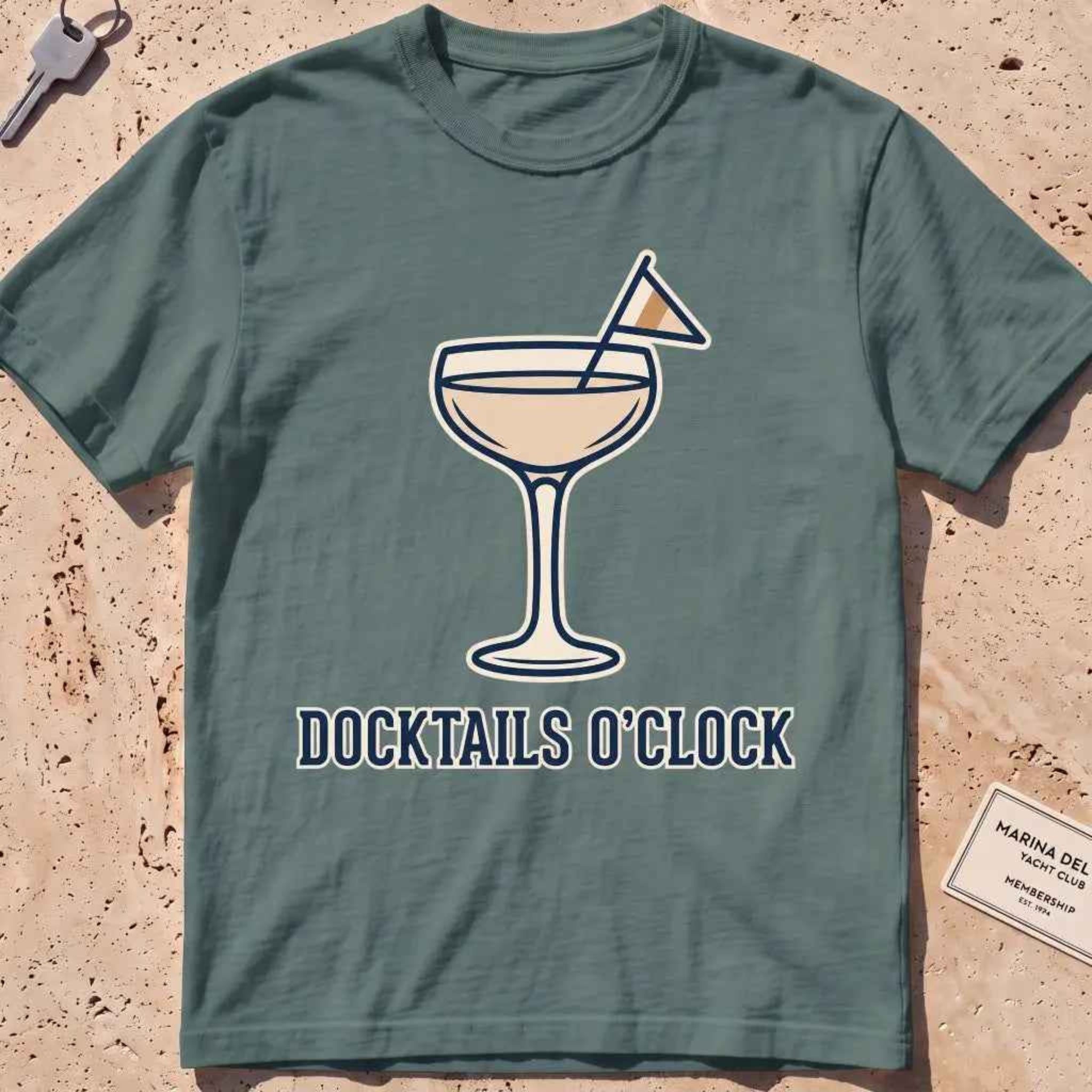 blue spruce heavyweight tee with a cocktail coupe, burgee and "Docktails O'Clock" text.