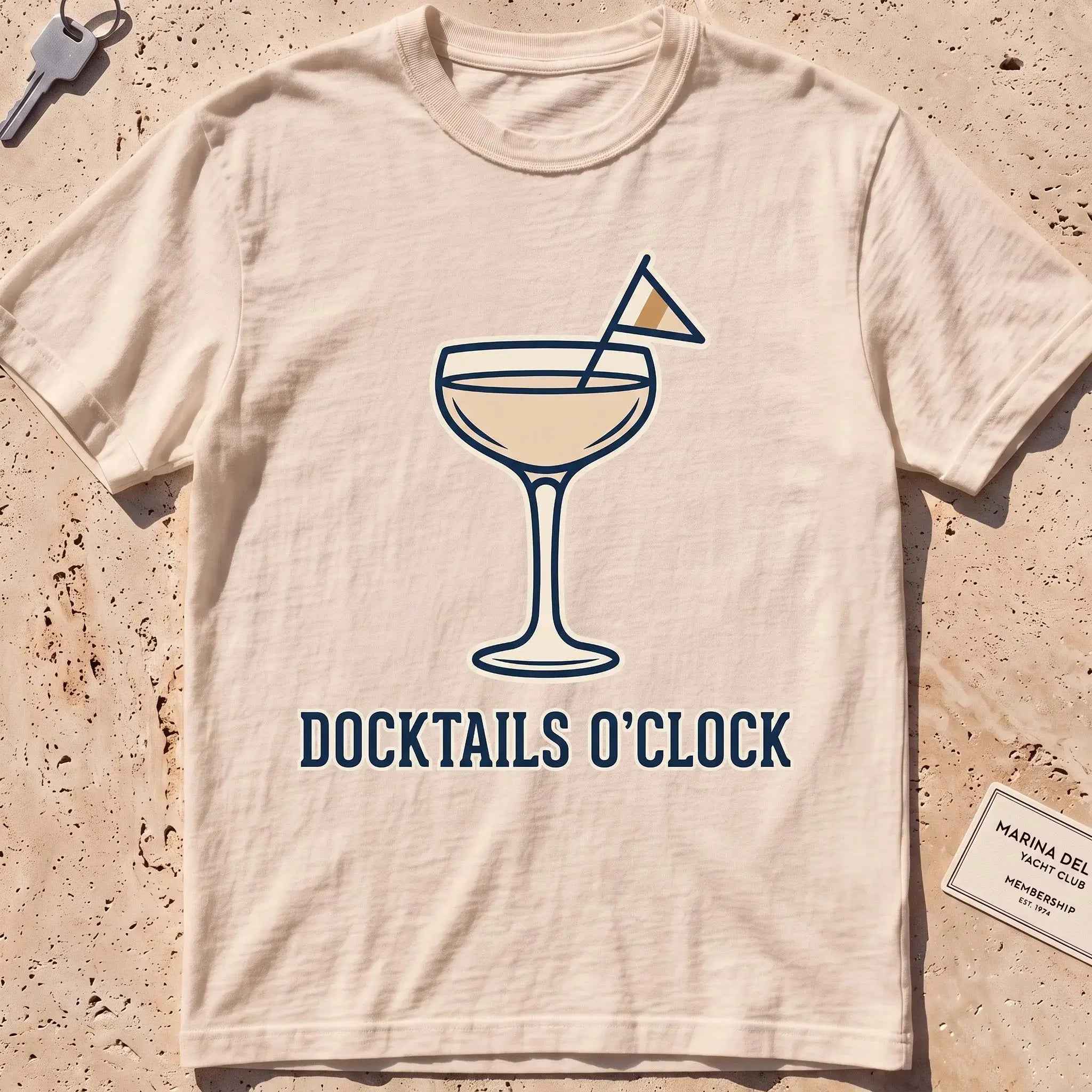 ivory heavyweight tee with a cocktail coupe, burgee and "Docktails O'Clock" text.
