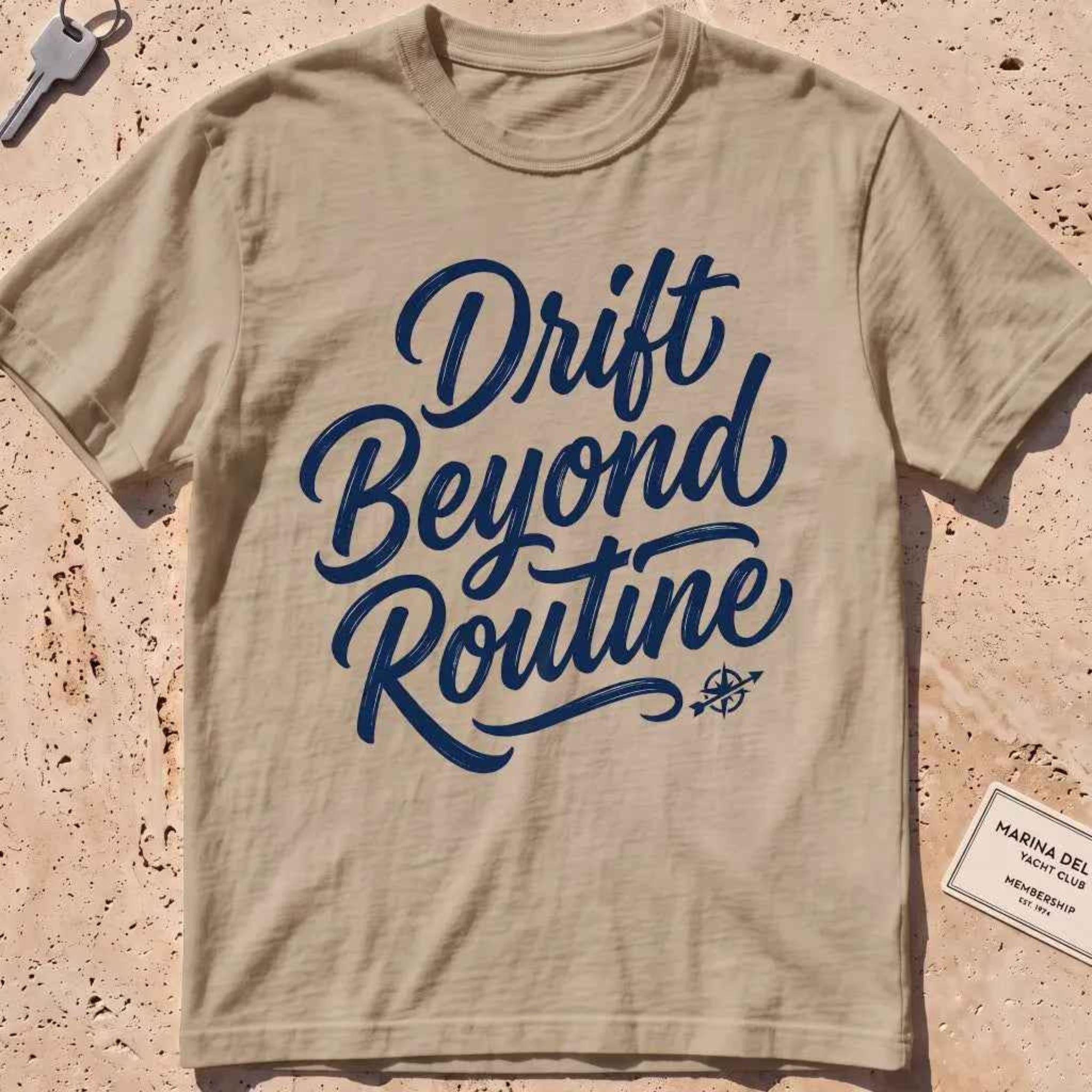 khaki heavyweight tee with brush-script "Drift Beyond Routine" typography.
