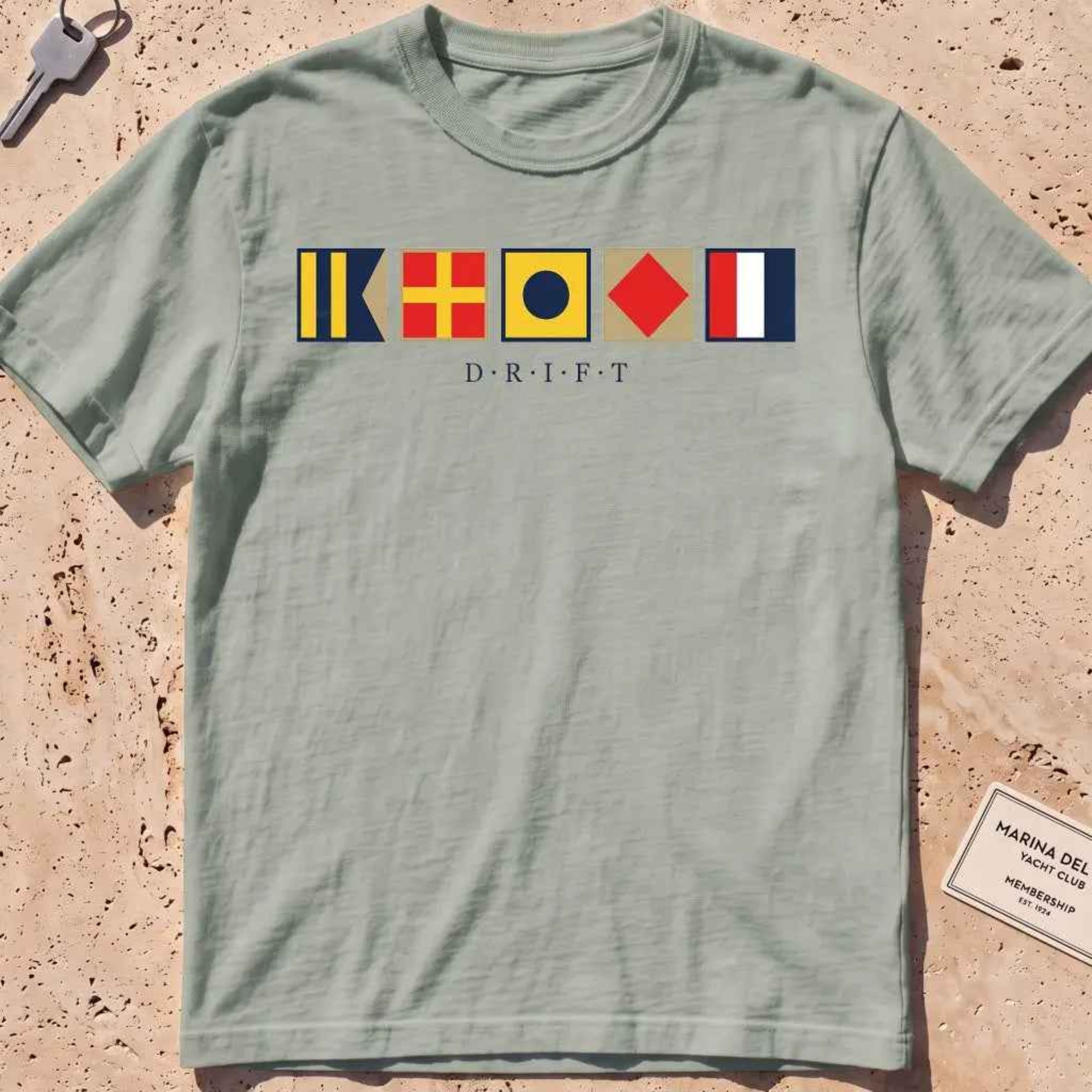 bay heavyweight tee with maritime signal flags spelling out the word "DRIFT."