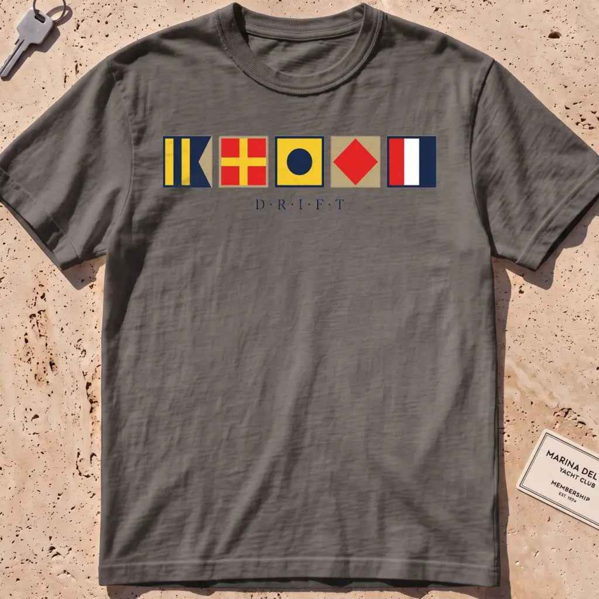 pepper heavyweight tee with maritime signal flags spelling out the word "DRIFT."