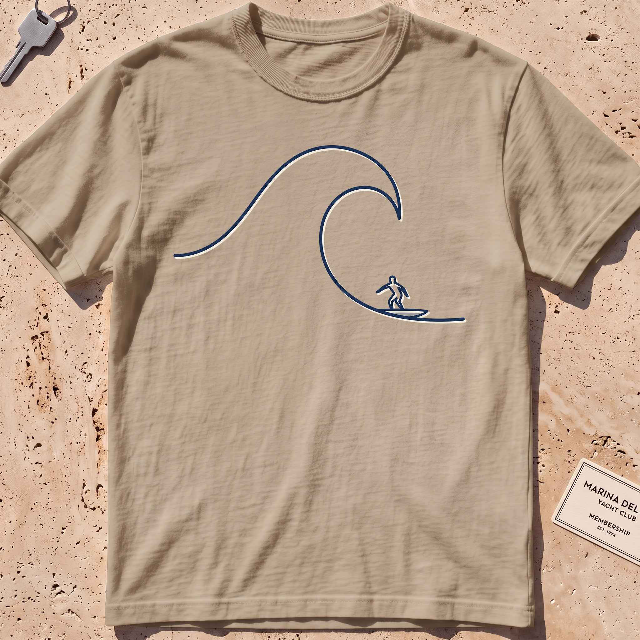 khaki heavyweight tee with a single-line surfer dropping into a wave graphic.