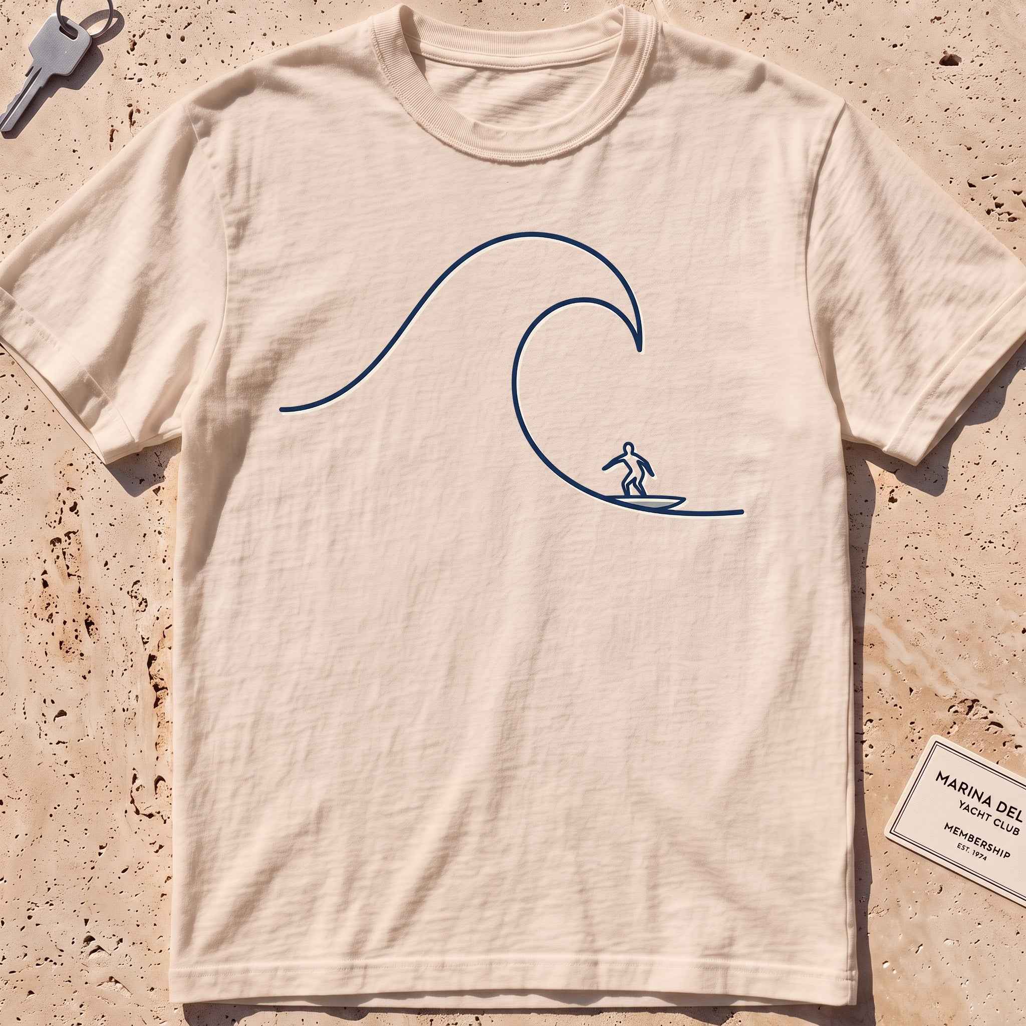 ivory heavyweight tee with a single-line surfer dropping into a wave graphic.