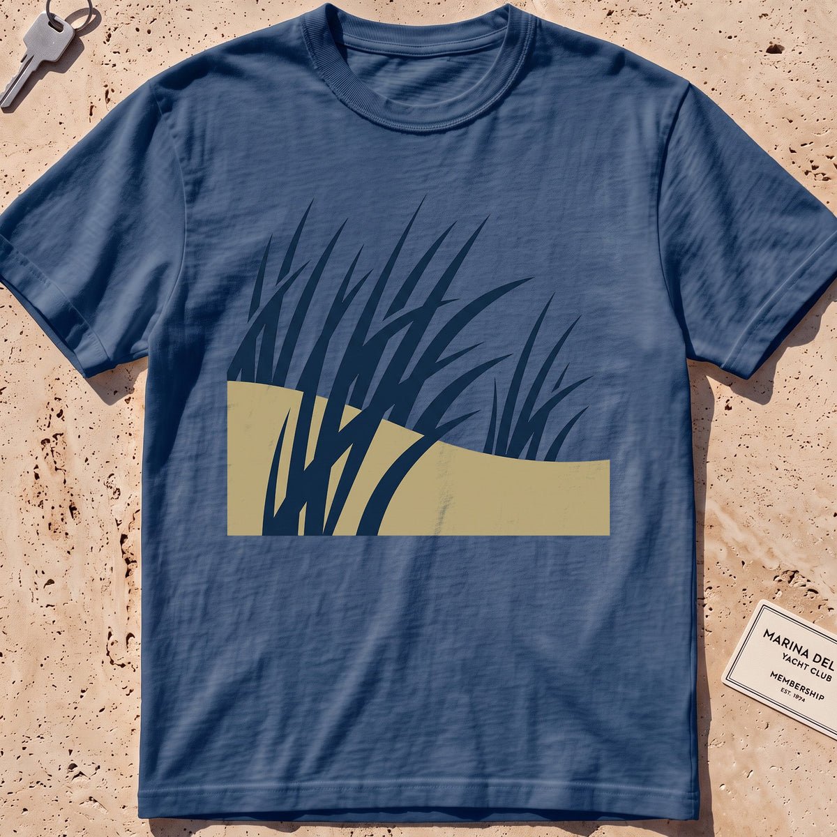 midnight heavyweight tee with flat-geometric wind-bent dune grass graphic.