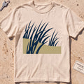 ivory heavyweight tee with flat-geometric wind-bent dune grass graphic.
