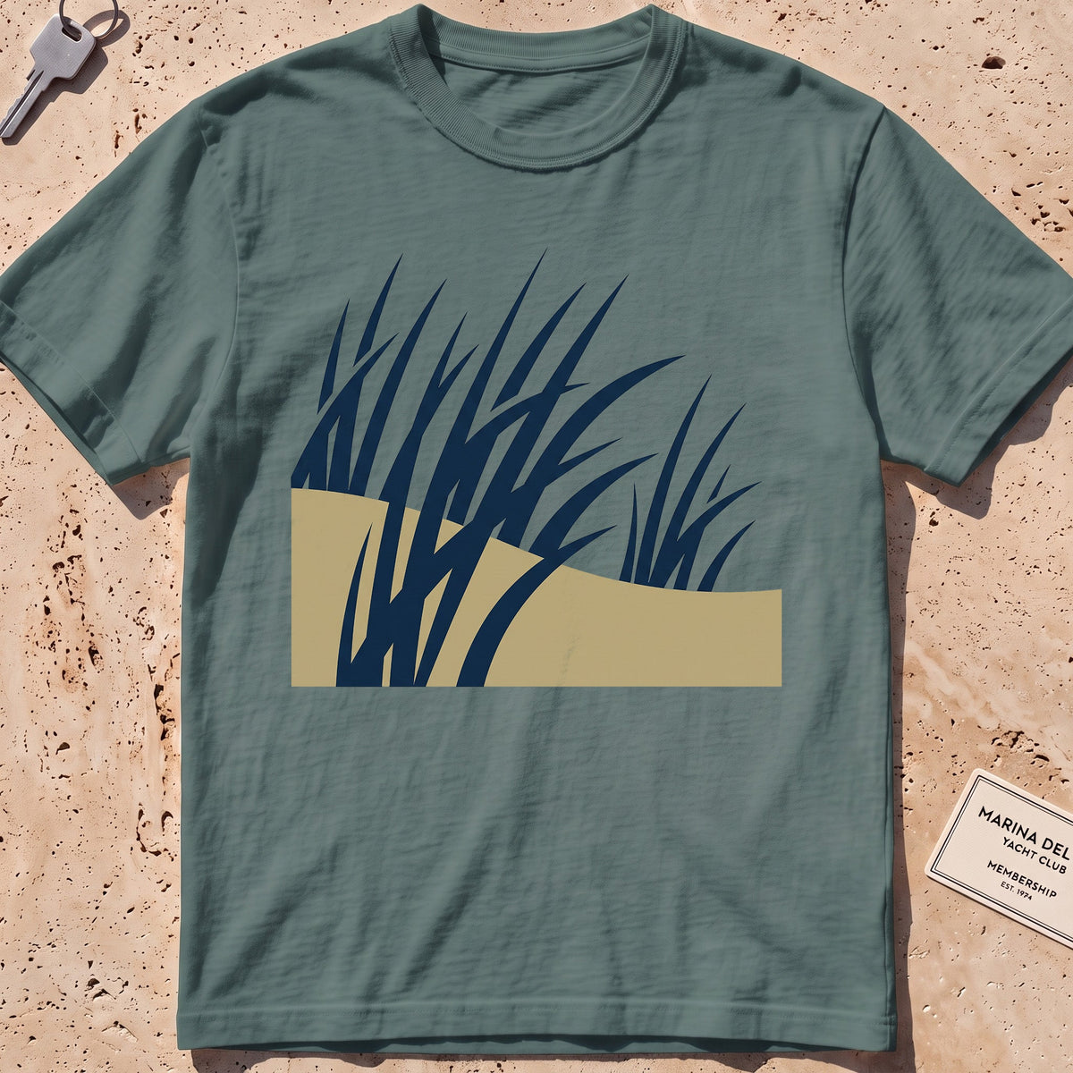 blue spruce heavyweight tee with flat-geometric wind-bent dune grass graphic.