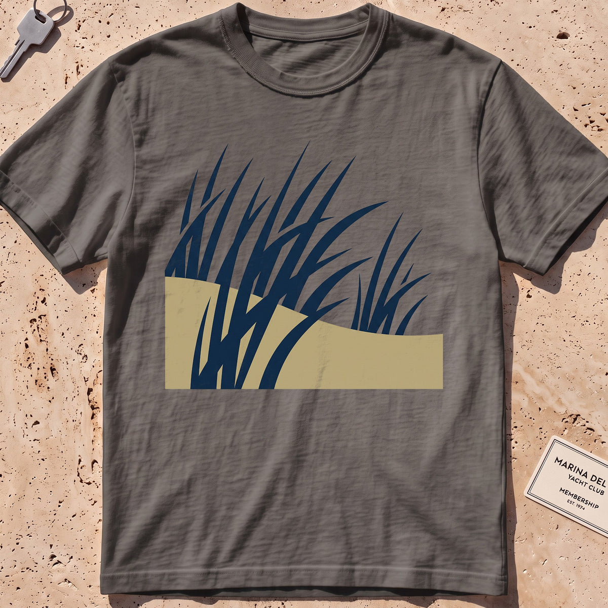 pepper heavyweight tee with flat-geometric wind-bent dune grass graphic.