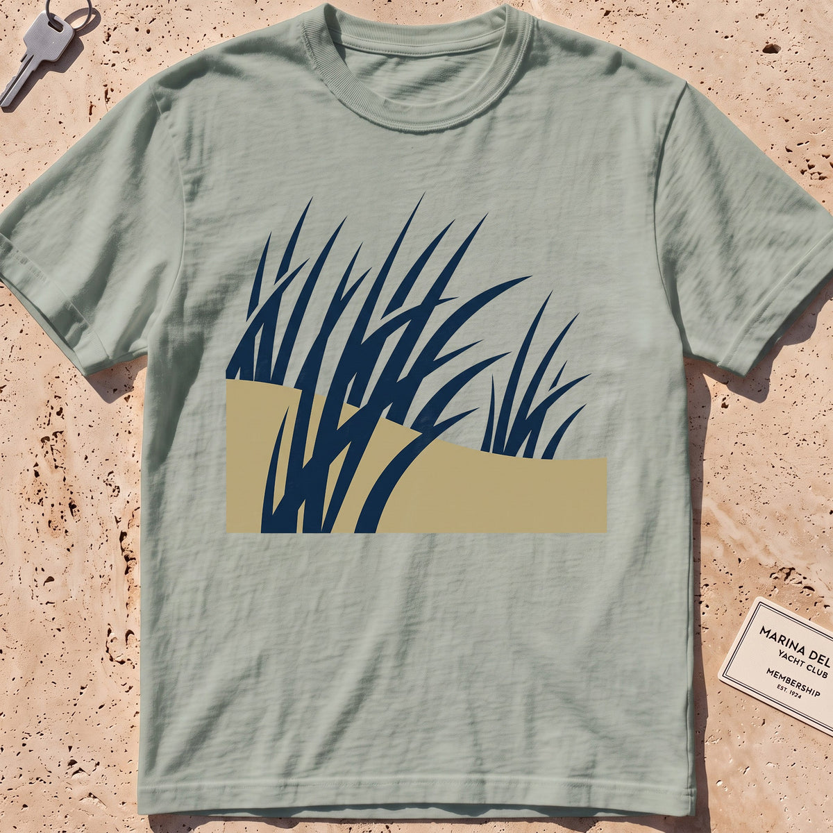 bay heavyweight tee with flat-geometric wind-bent dune grass graphic.