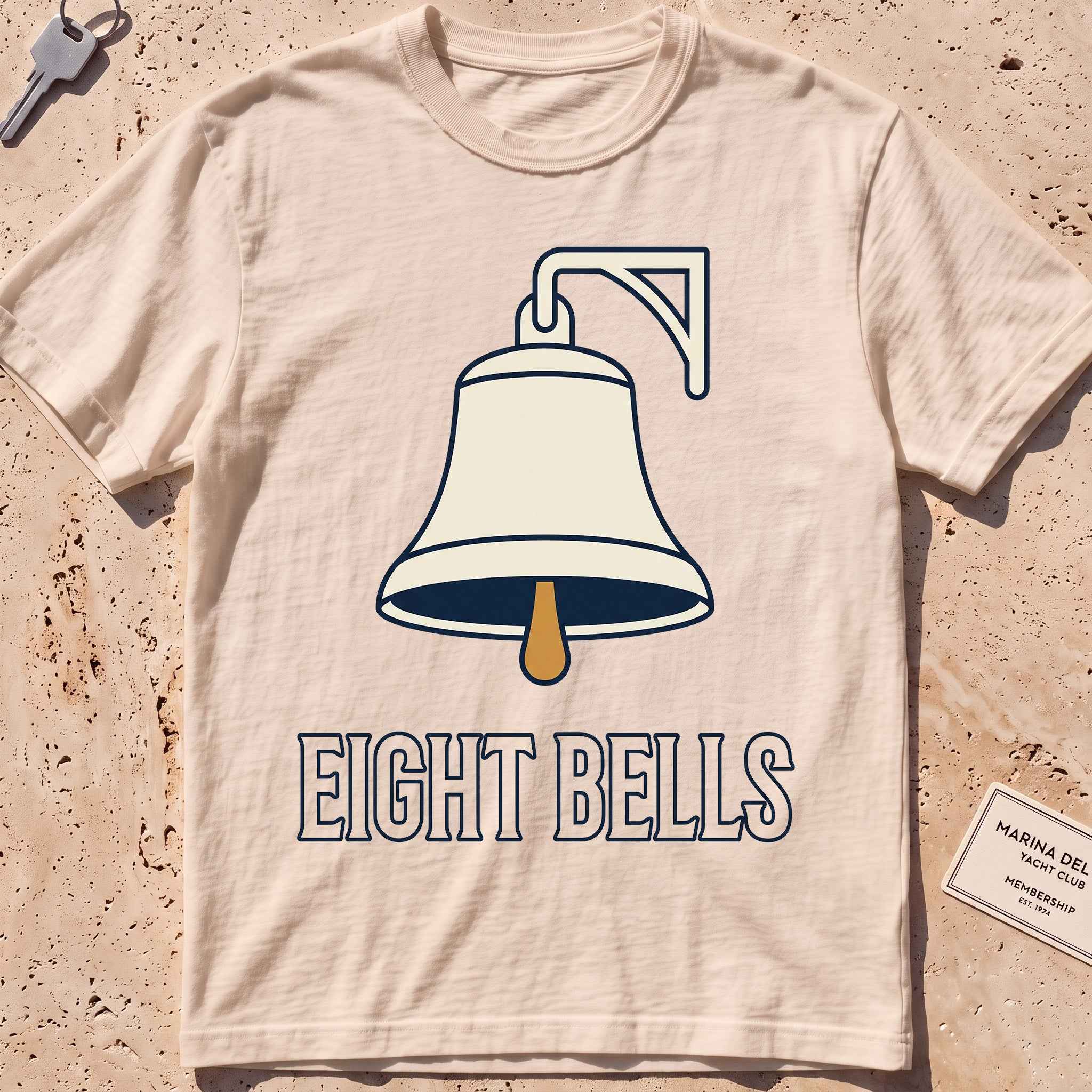 ivory heavyweight tee with a bold ship's-bell "Eight Bells" graphic.