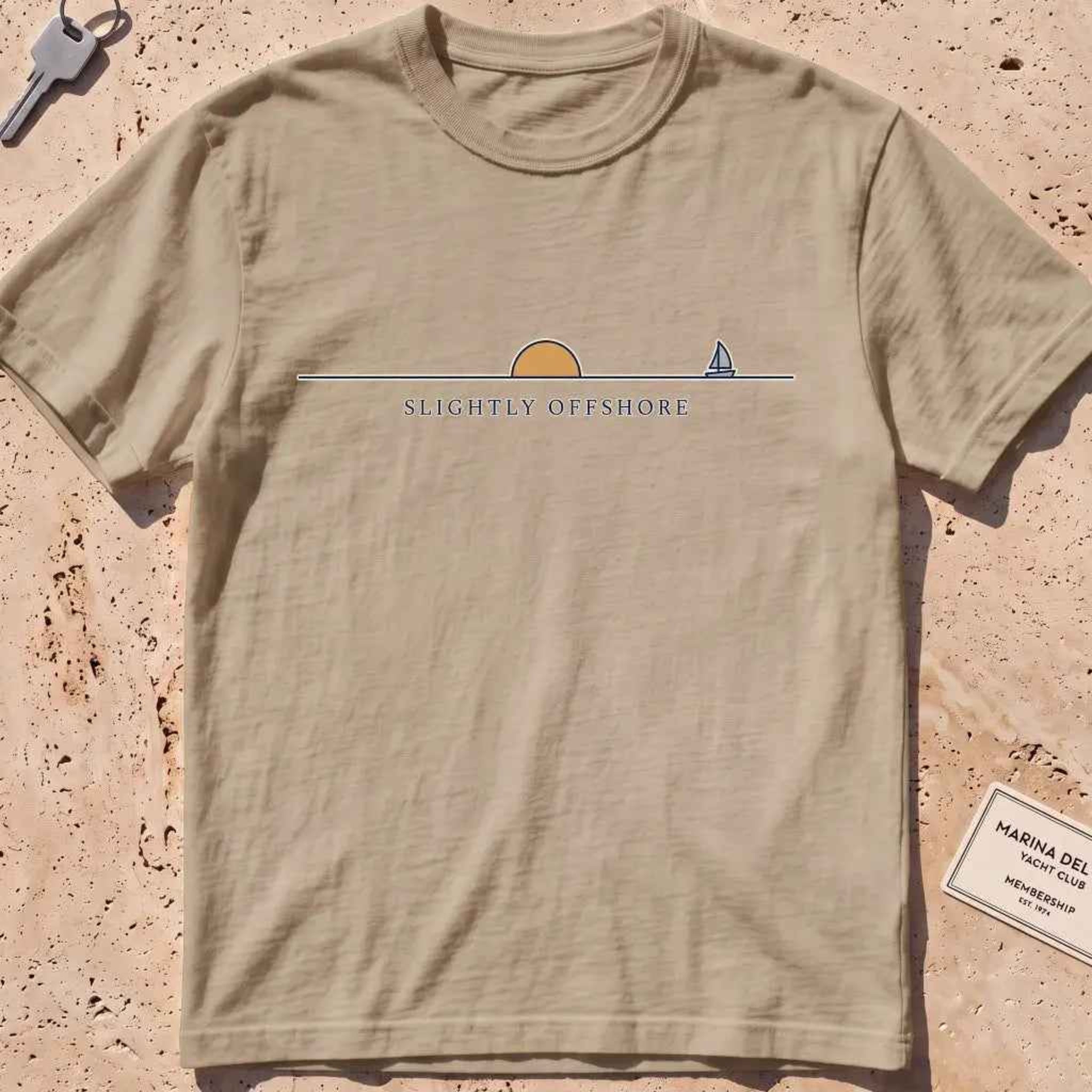 khaki heavyweight tee with an ochre half-sun, horizon line and tiny sailboat.