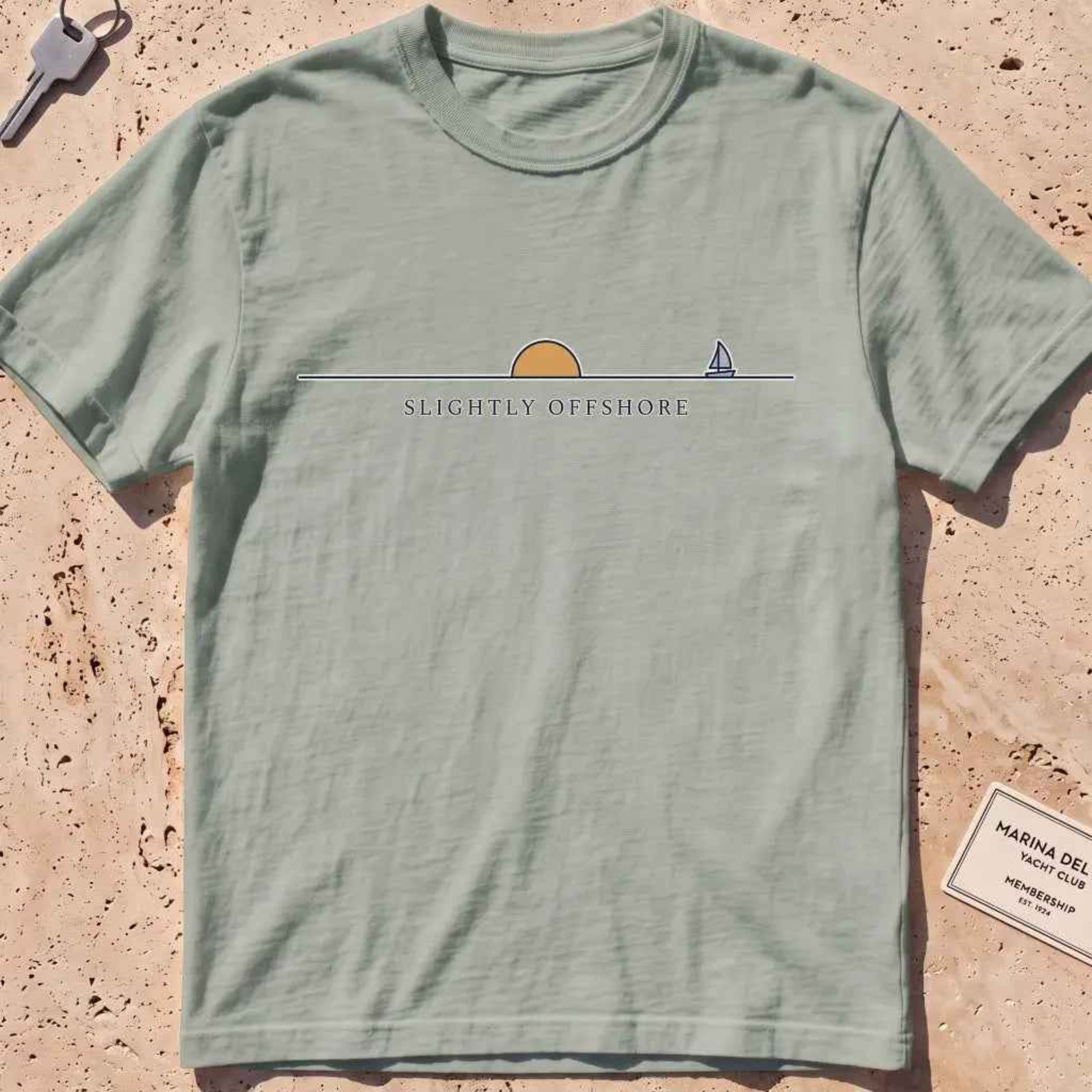 bay heavyweight tee with an ochre half-sun, horizon line and tiny sailboat.