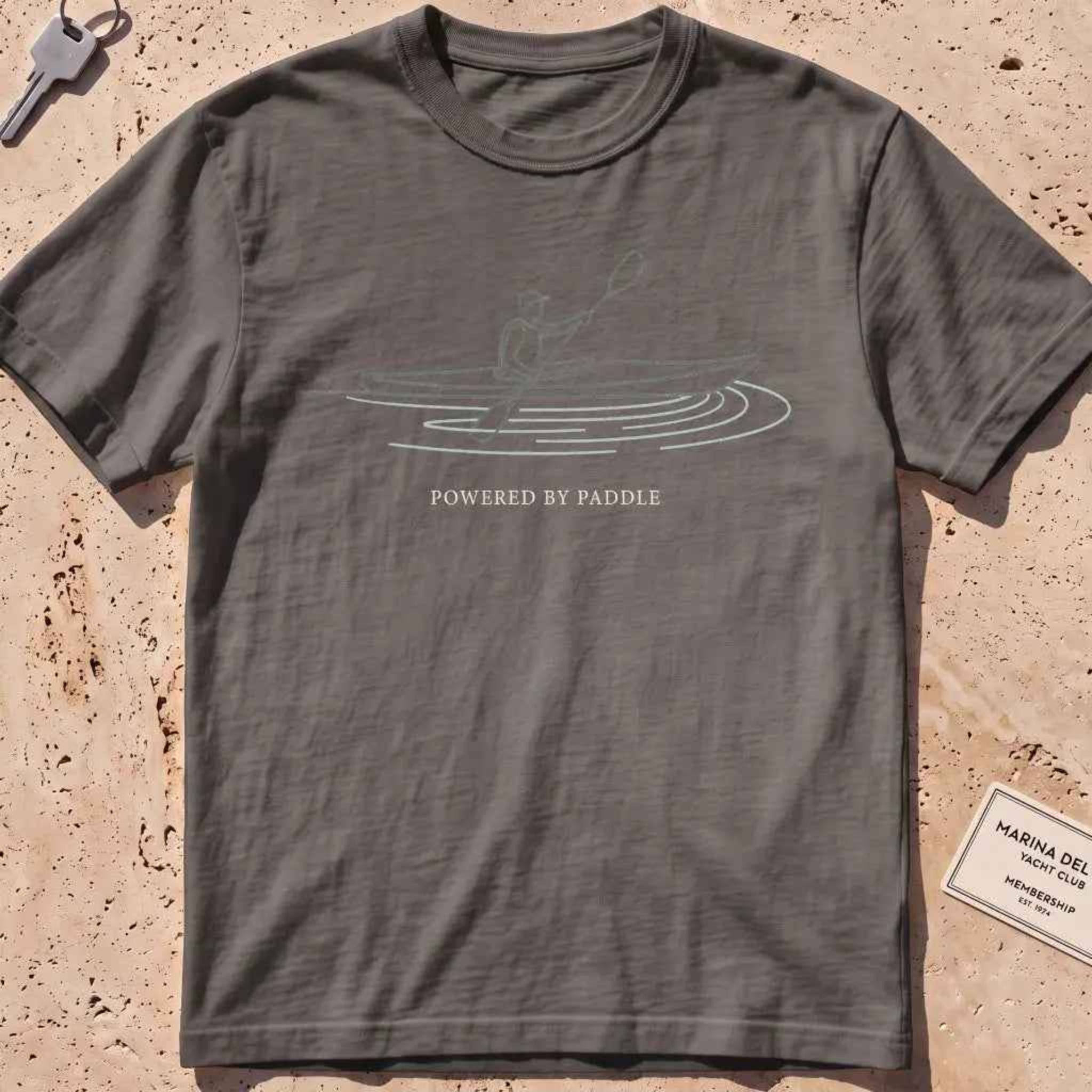 pepper heavyweight tee with a single-line kayaker "Powered by Paddle" graphic.