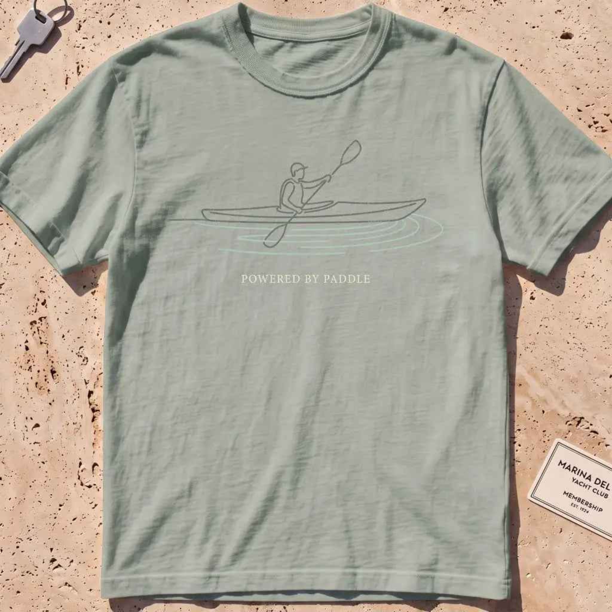 bay heavyweight tee with a single-line kayaker "Powered by Paddle" graphic.